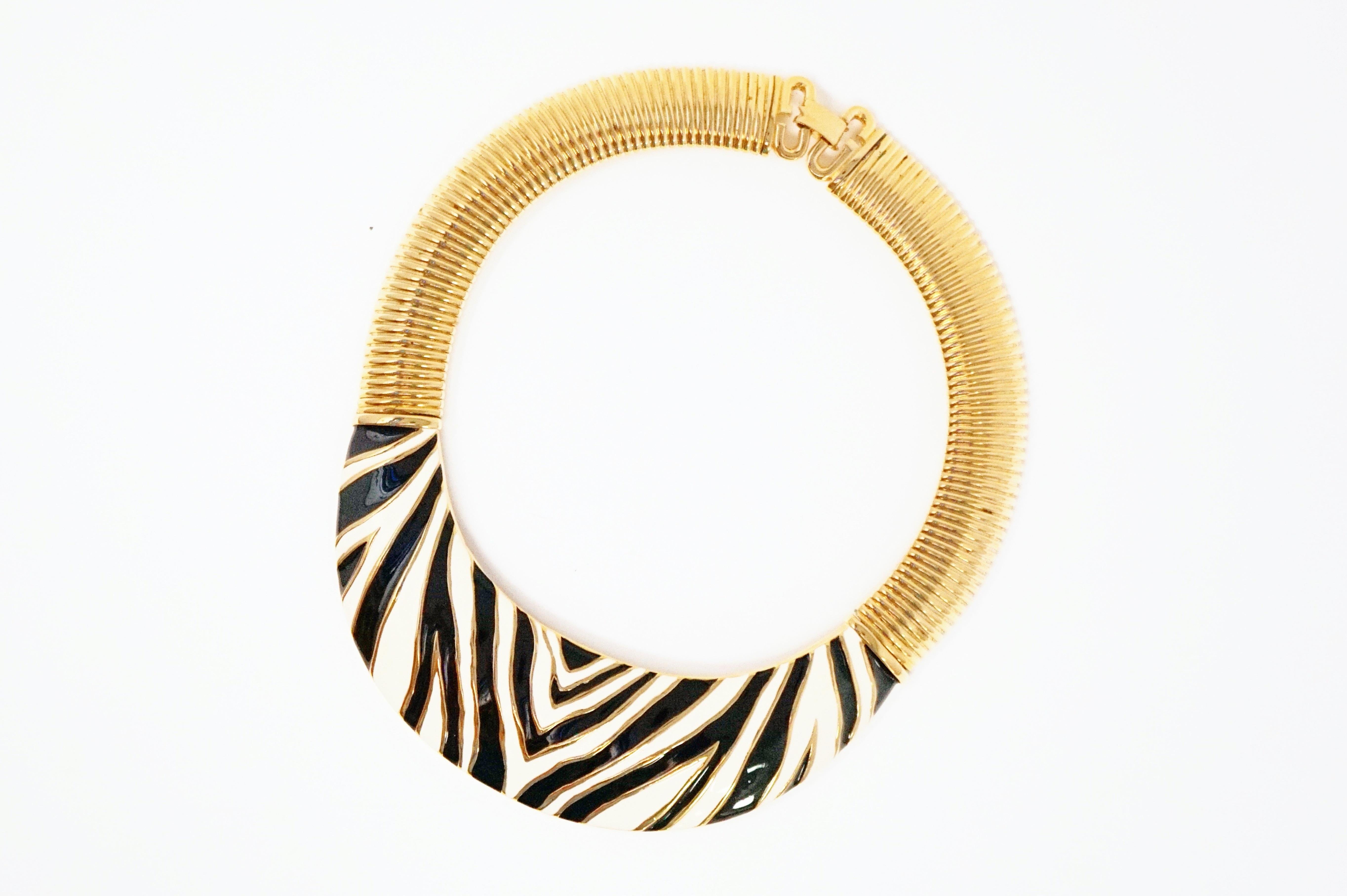 - Oversized, quintessential 80s piece
- Zebra motif
- Gold plated
- Black & white enamel detail
- Thick snake chain
- Signature 