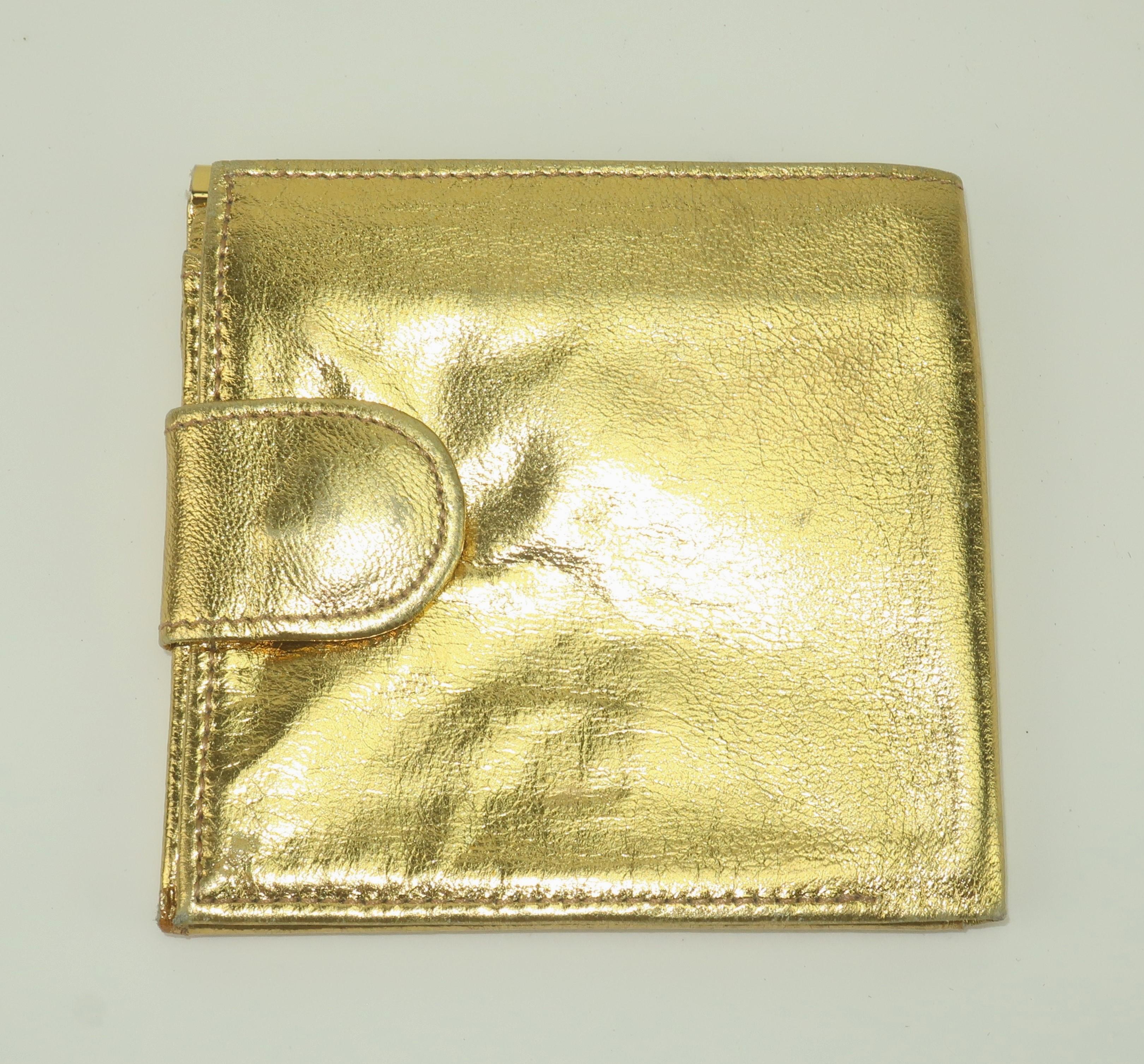 Get the Midas touch with a 1960's Givenchy gold leather evening billfold wallet.  The iconic Givenchy logo is impressed on the flap of the coin compartment and on the flip-side a tab snap opens to reveal two compartments for dollar bills with a