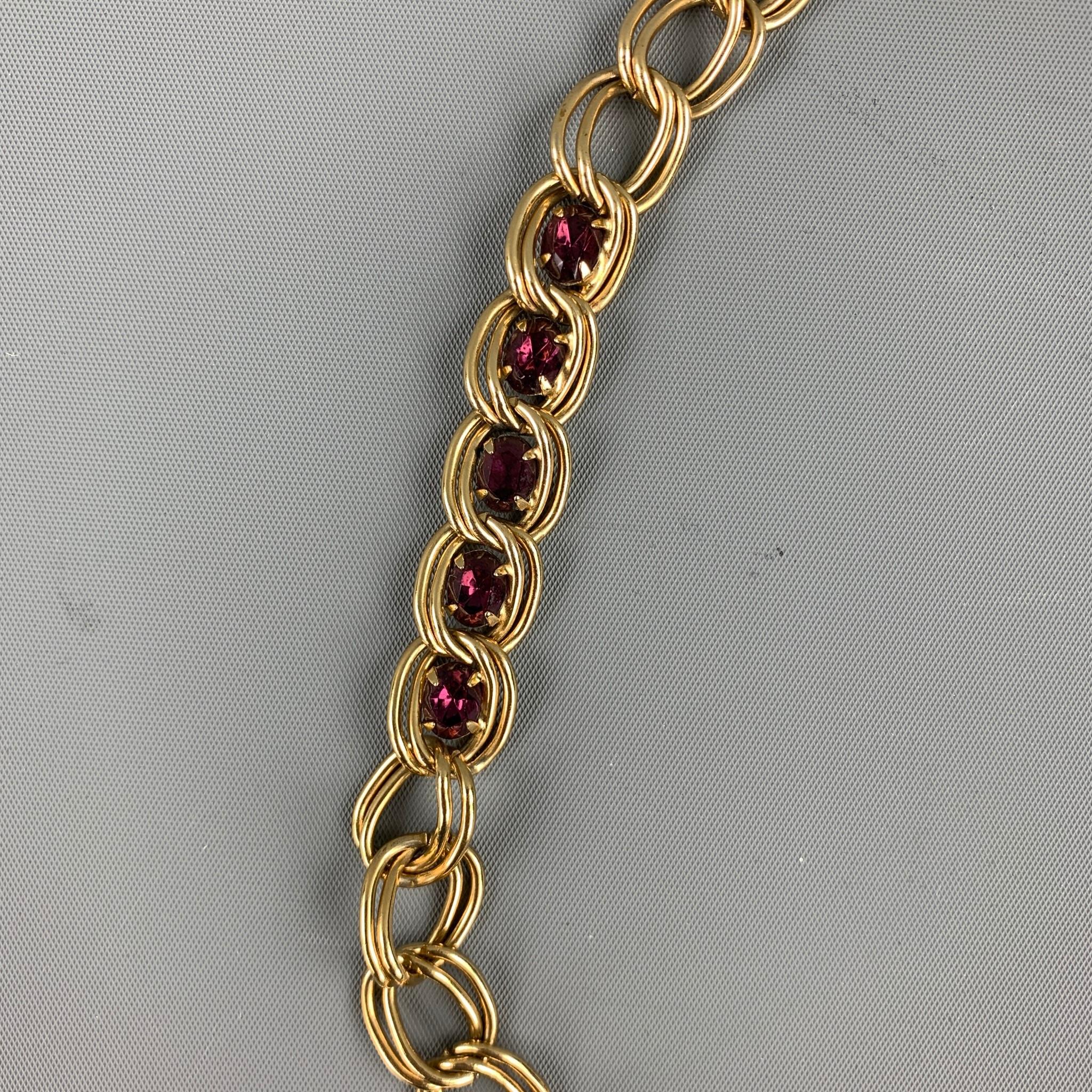 GIVENCHY necklace comes in a gold tone chain link with purple stones featuring a snap clasp closure. 

Very Good Pre-Owned Condition.

Measurements:

Length: 28 in.