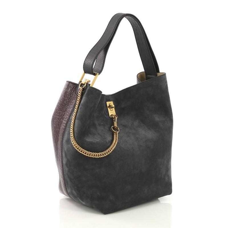 This Givenchy GV Bucket Bag Leather and Suede Medium, crafted from burgundy leather and green suede, features adjustable shoulder strap, hanging chain clips at front, and aged gold-tone hardware. Its turn-lock closure opens to a beige suede
