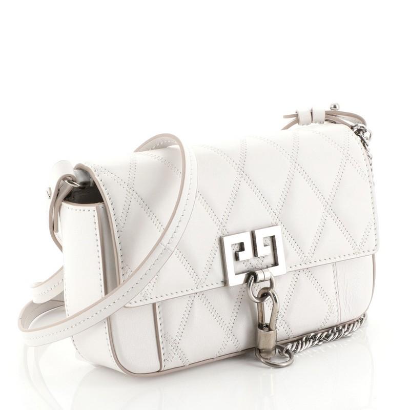 This Givenchy GV3 Convertible Shoulder Bag Quilted Leather Mini, crafted in white quilted leather, features chain link detail, leather shoulder strap, flap top with logo, and aged silver-tone hardware. Its magnetic closure opens to a neutral