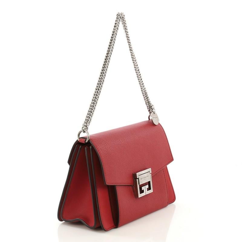 This Givenchy GV3 Flap Bag Leather Small, crafted in red leather, features chain and leather shoulder strap, flap top with logo-engraved flip-lock closure, exterior front zip, and silver-tone hardware. Its flip-lock closure opens to a beige