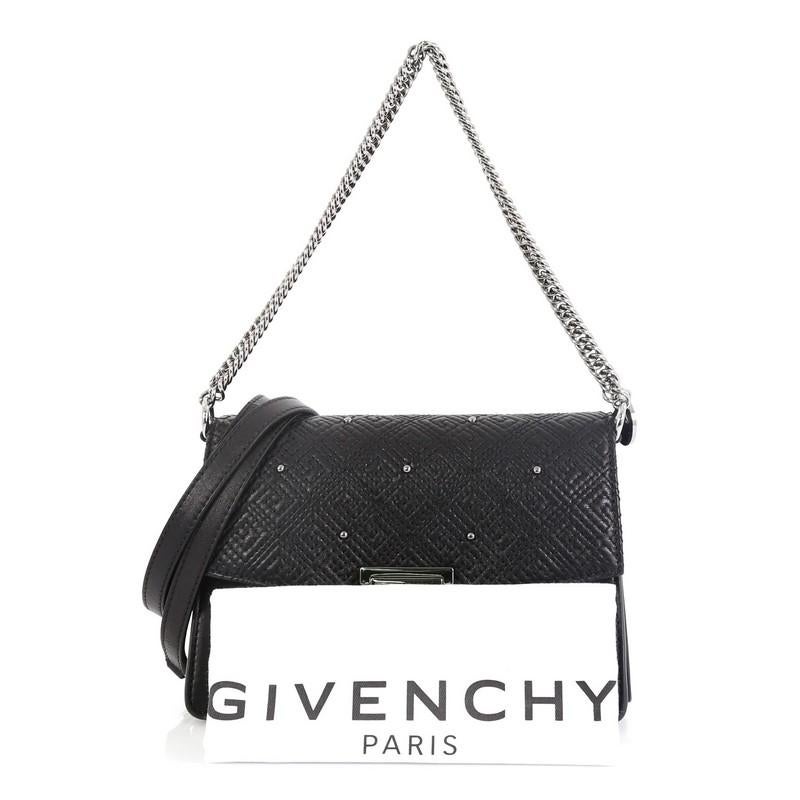 This Givenchy GV3 Flap Bag Studded Embroidered Lambskin Small, crafted in black studded embroidered lambskin leather, features chain link handle, leather shoulder strap, and silver-tone hardware. It flap opens to a black microfiber interior.
