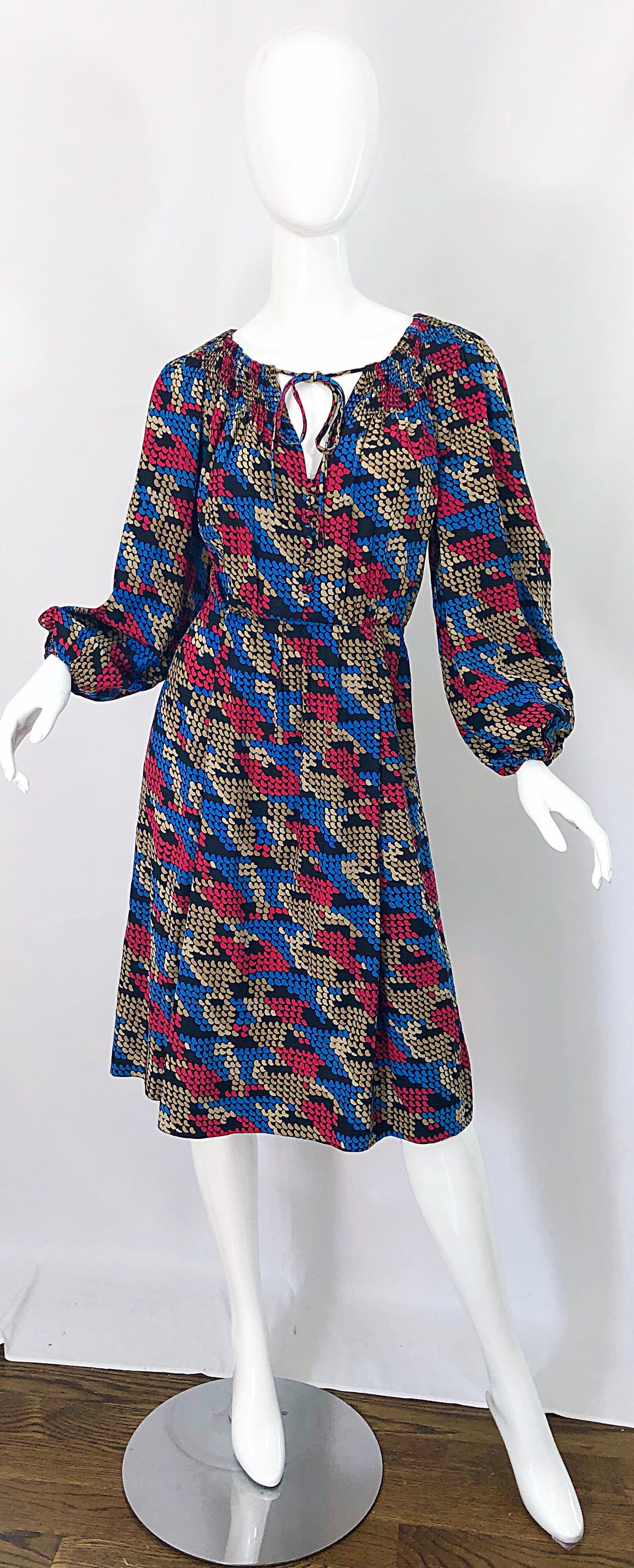 Amazing vintage 70s GIVENCHY HAUTE COUTURE exaggerated houndstooth bishop sleeve silk dress! Features vibrant colors of fuchsia pink, blue, grey and black throughout. Ties at neck can be worn multiple ways. Hidden metal zipper up the side. 
Chic