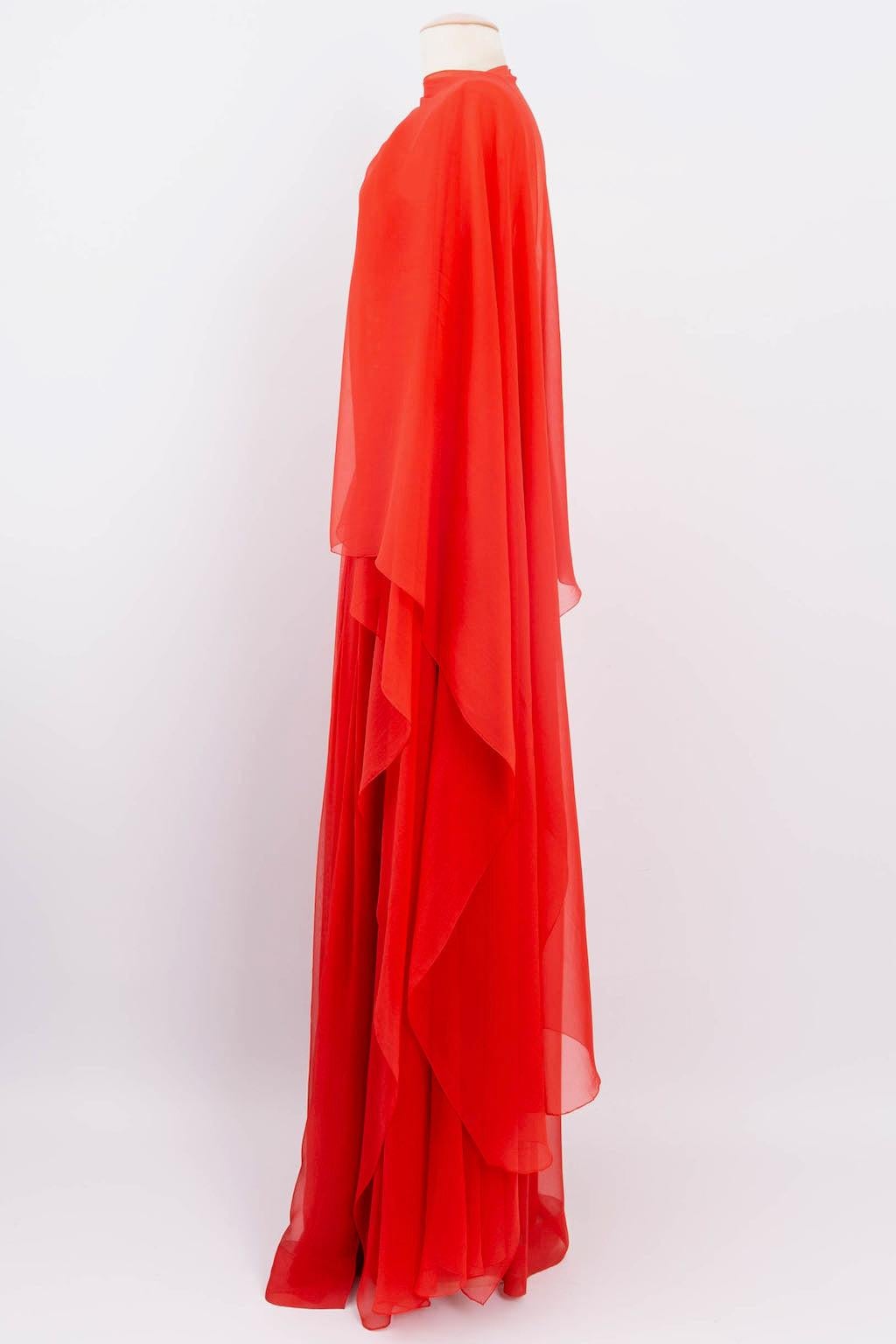 Givenchy Haute Couture (Made in France) Amazing dress composed of red silk chiffon embroidered with beads, cabochons, and sequins. It is accompanied by a long stole that can be tied around the neck. Ribbon N°66420. 
No composition or size tag, it