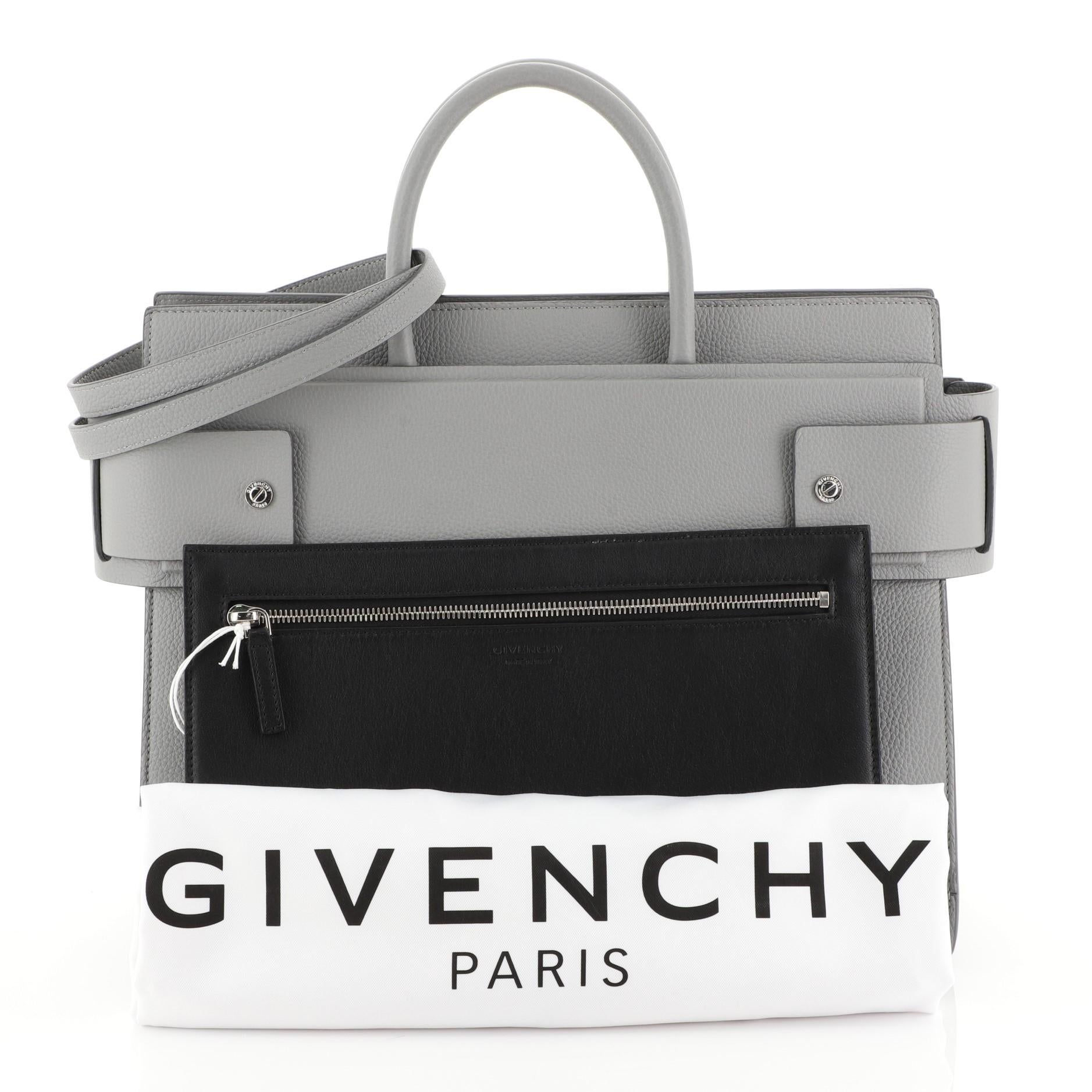This Givenchy Horizon Satchel Leather Medium, crafted from gray leather, features dual rolled top handles, belted open top with snap sides, embossed logo at front and silver-tone hardware. It opens to a black leather interior. 

Estimated Retail
