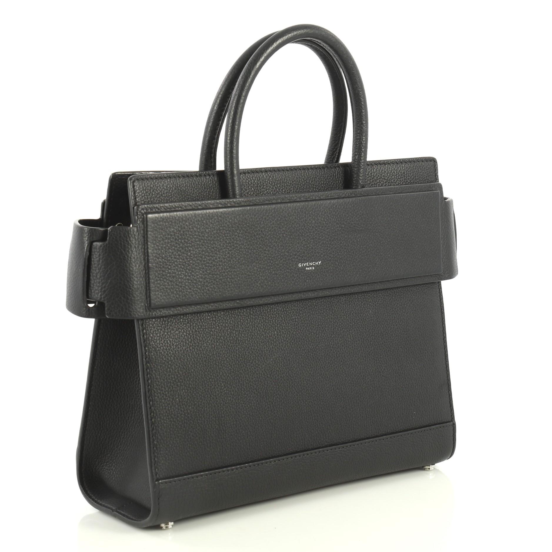 This Givenchy Horizon Satchel Leather Small, crafted from black leather, features dual rolled top handles, belted open top with snap sides, embossed logo at front and silver-tone hardware. It opens to a black leather interior with slip pockets.