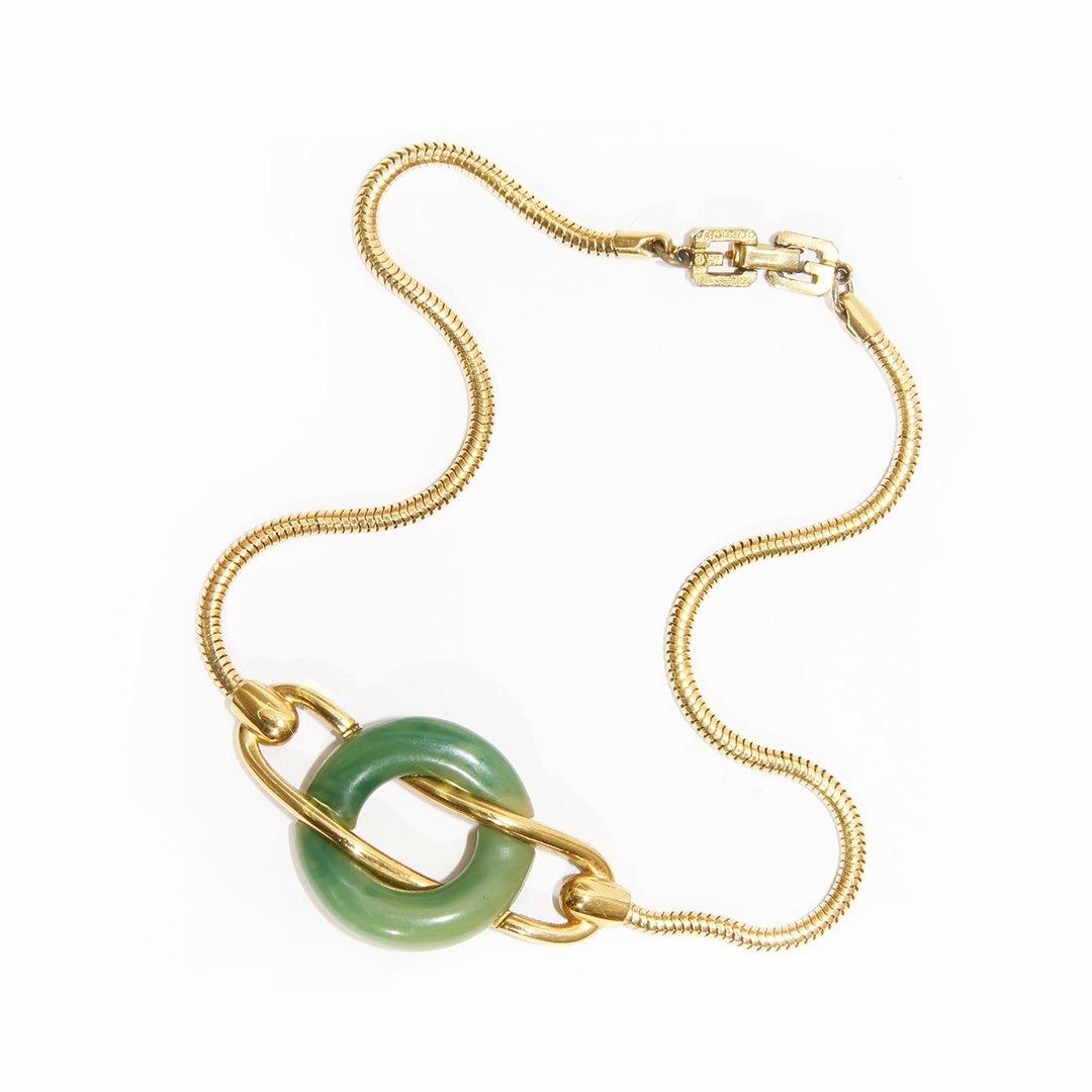 Jade choker necklace by Givenchy 
Vintage
Jade stone 
Gold-tone hardware 
Metal and jade intertwined design 
Clasp closure 
Condition: Excellent condition, Consistent with wear and age. Sold as-is.(see photos) 

Size/Measurements:
14