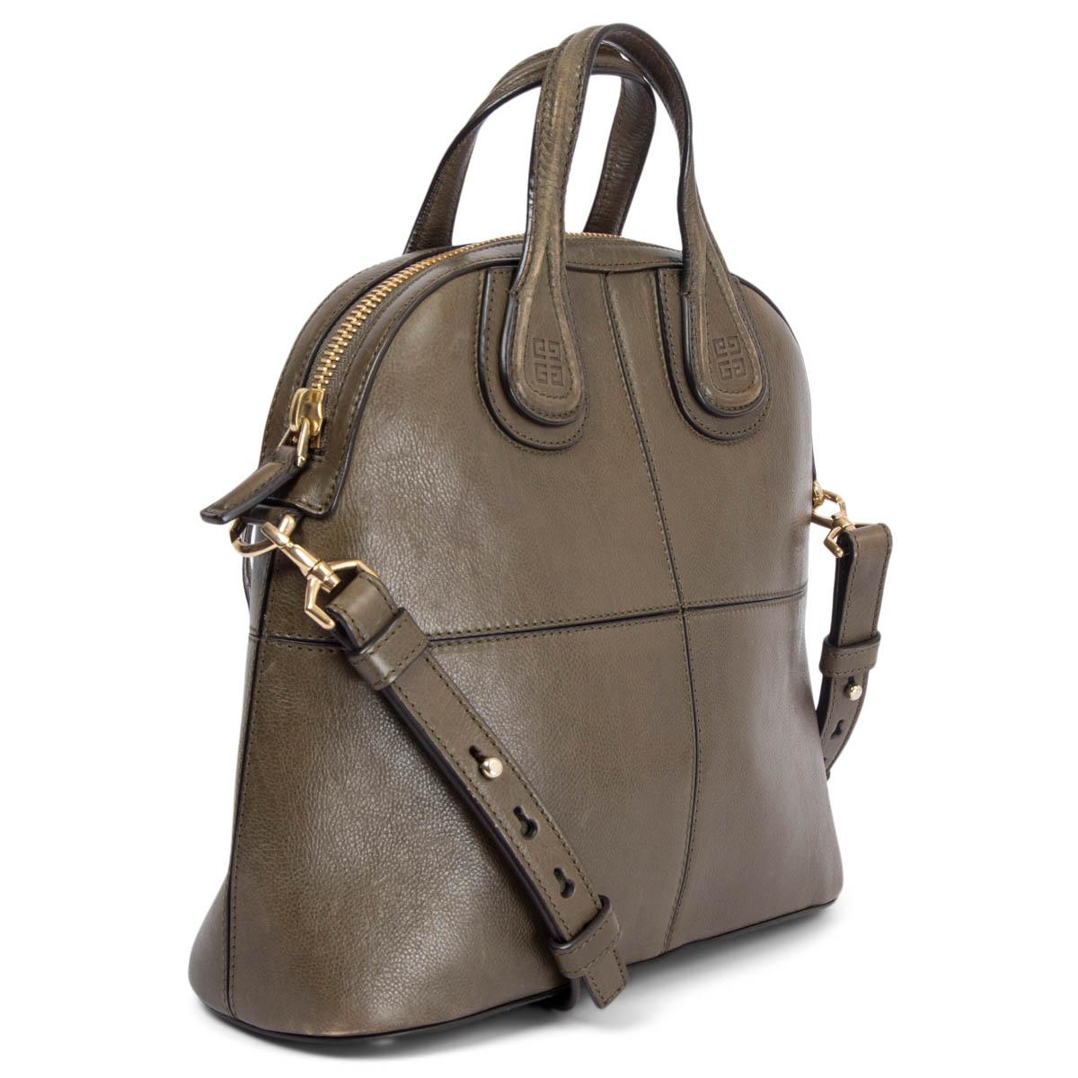 100% authentic Givenchy Nightingale top handle shoulder bag in khaki green calfskin with light gold-tone hardware. Opens with a zipper on top and is lined in black canvas with one zipper pocket against the back and a small open pocket against the