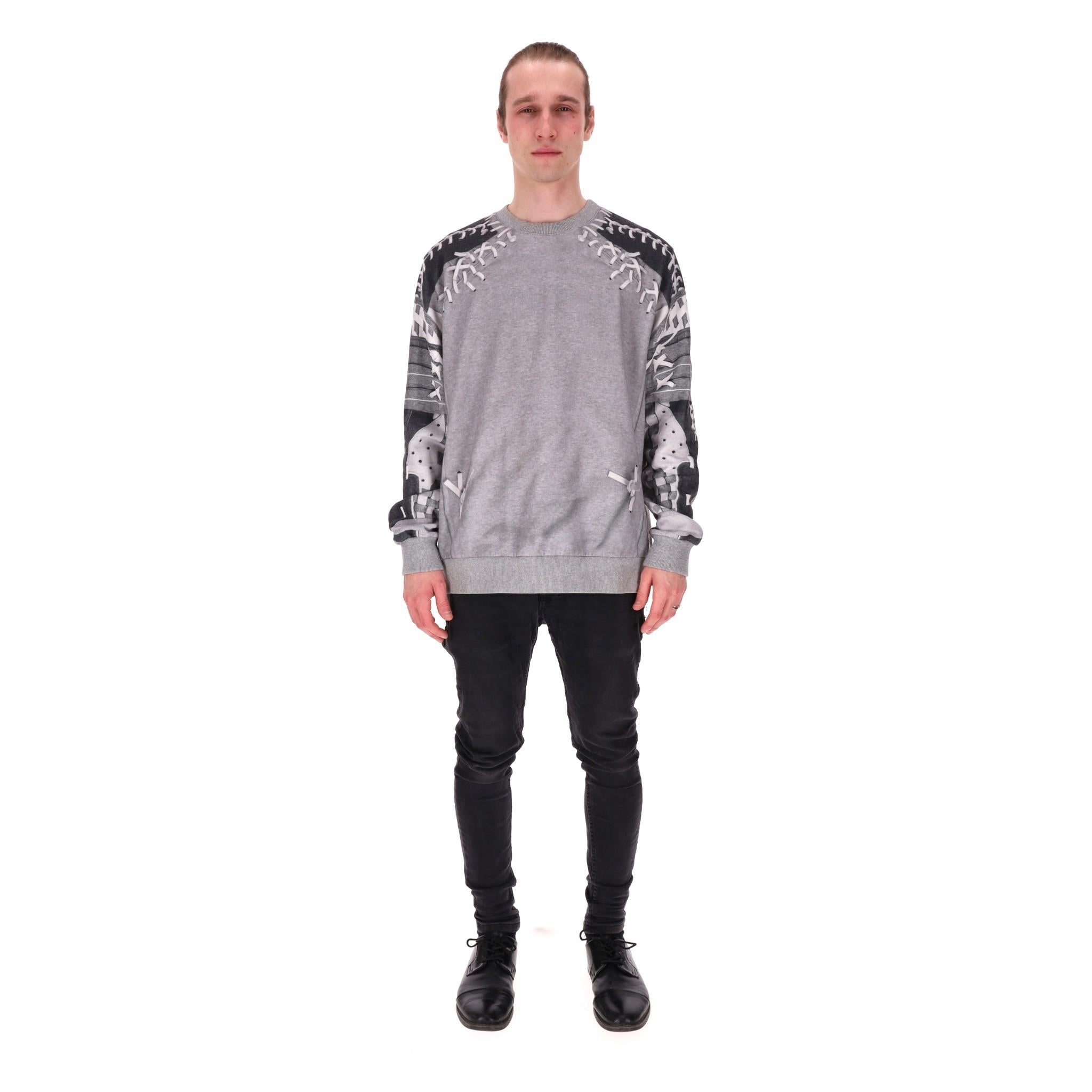 Givenchy Lace-Up Detail Sweatshirt

Grey sweatshirt with white lace-up embellishment to the shoulder, rear and sleeves.

Featuring printed long sleeves, ribbed crew neckline, cuffs and hem.

Rrp Approx. £950

Size – S

Condition – Very