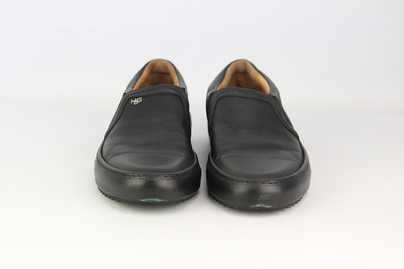Givenchy leather slip on sneakers. Made from black leather in a classic slip-on sneaker style with the brand’s silver-tone logo on the side. Black. Slip on. Does not come with box or dustbag. Size: EU 43 (UK 9, US 10). Insole: 11.1 in. Heel: 1.25 in