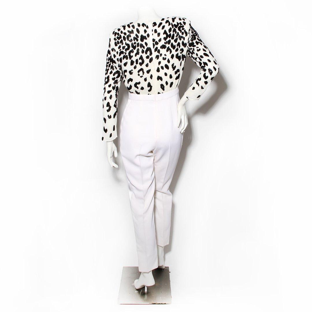Givenchy by Clare Waight Keller Jumpsuit 
Chiffon long sleeve 
Leopard print in black velvet 
Low V neckline 
Shoulder pads 
Button at back for closure 
Zipper on back with hook and eye closure
Keyhole detail in back of dress
Satin ivory tuxedo