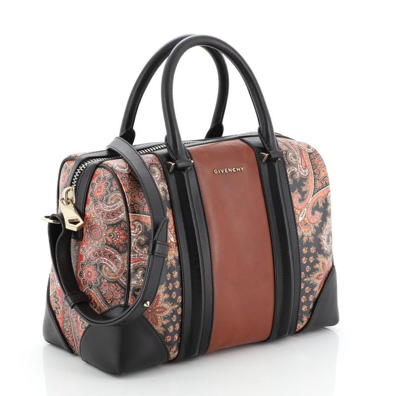 This Givenchy Lucrezia Duffle Bag Printed Leather Medium, crafted from brown printed leather leather features a gold Givenchy logo at the front exterior, dual-rolled leather handles and gold-tone hardware. Its zip closure opens to a spacious black