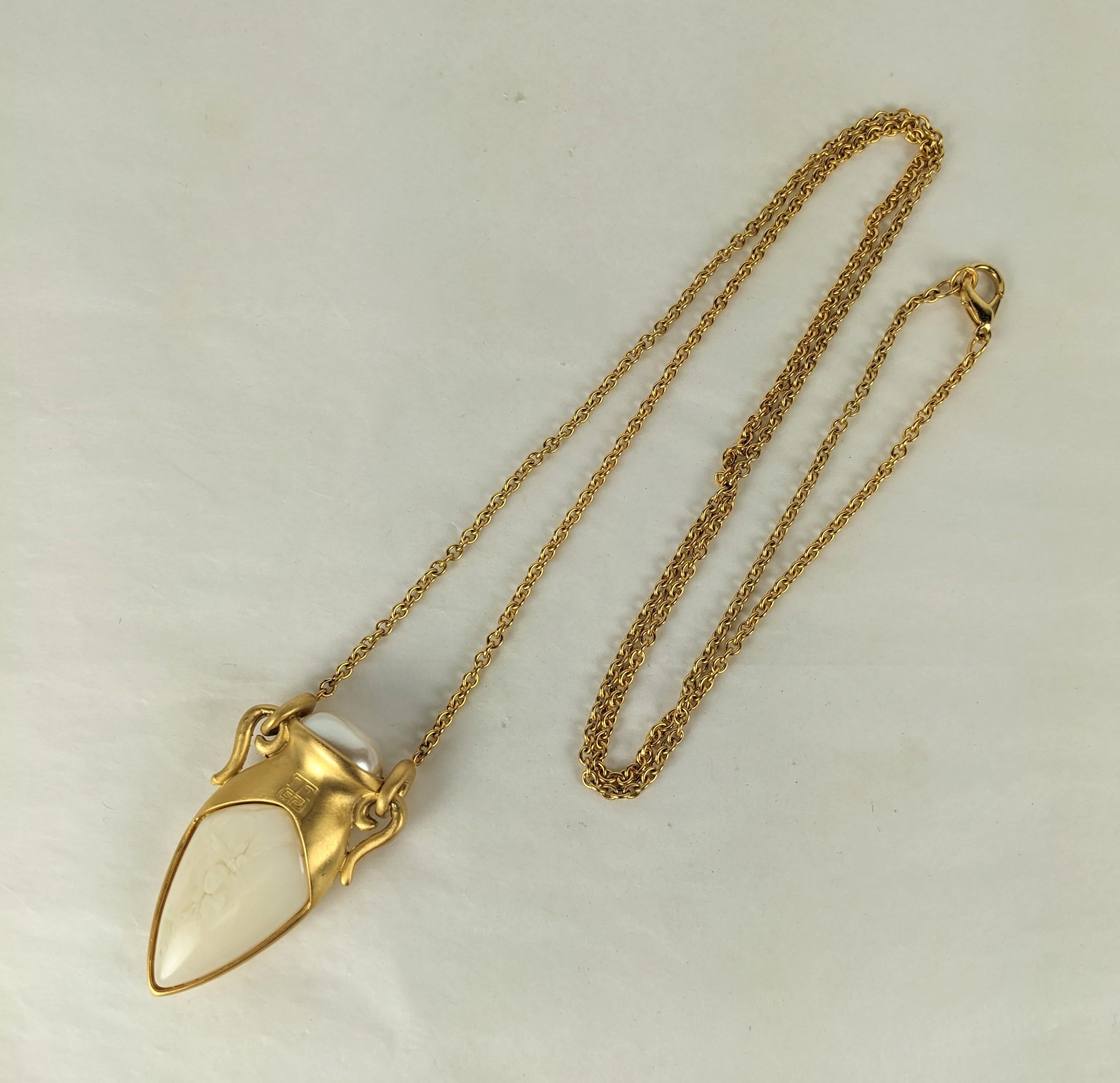 Unusual Givenchy Matte Gold Amphora Pendant on a long versatile chain. Set with a faux ivory bakelite body and faux pearl top with Givenchy Logo on front.
1990's France,  2.5
