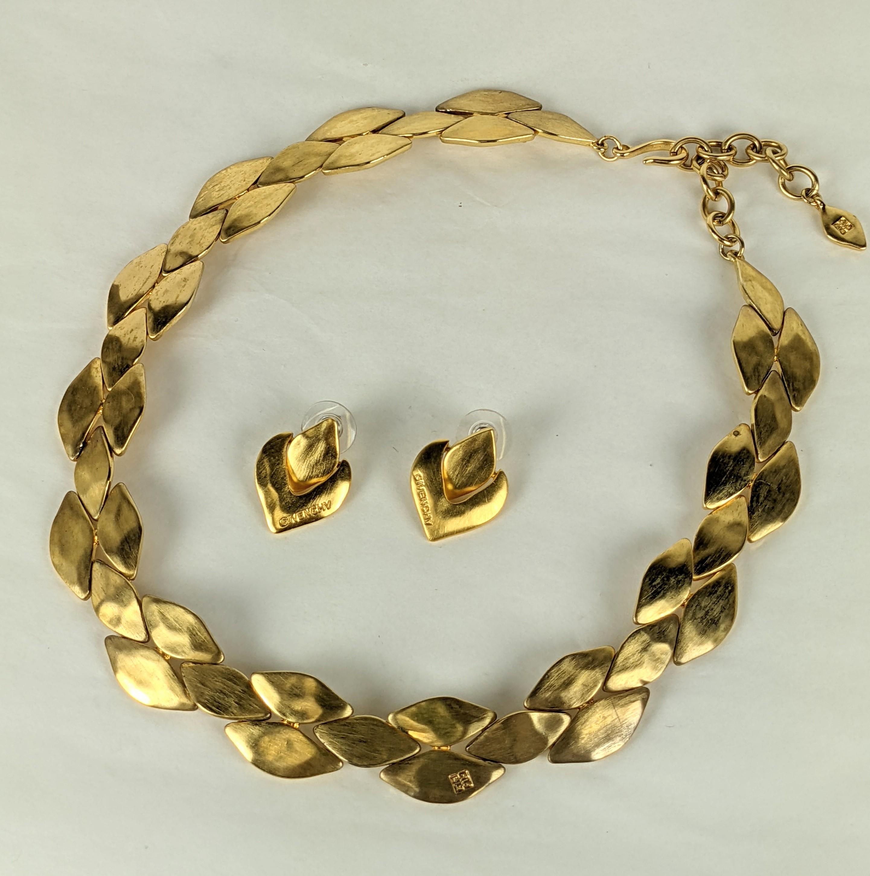 Givenchy Matte Gold Suite from the 1990's. Hammered flexible link adjustable necklace and matching pierced earrings. Many Givenchy logos are placed on the earrings and on the necklace. 
1990's France. Necklace , 16