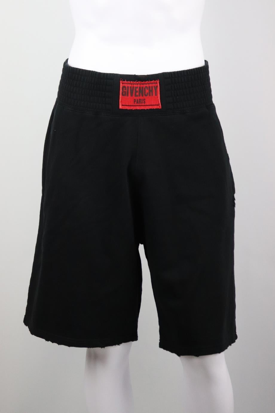 Givenchy men's distressed cotton shorts. Black and red. Pull on.100% Cotton. Size: XLarge (EU 52, IT 52, UK/US Waist 36). Waist: 34 in. Hips: 54 in. Length: 23 in. Inseam: 10 in. Rise: 15 in. Very good condition - No sign of wear; see pictures. 
