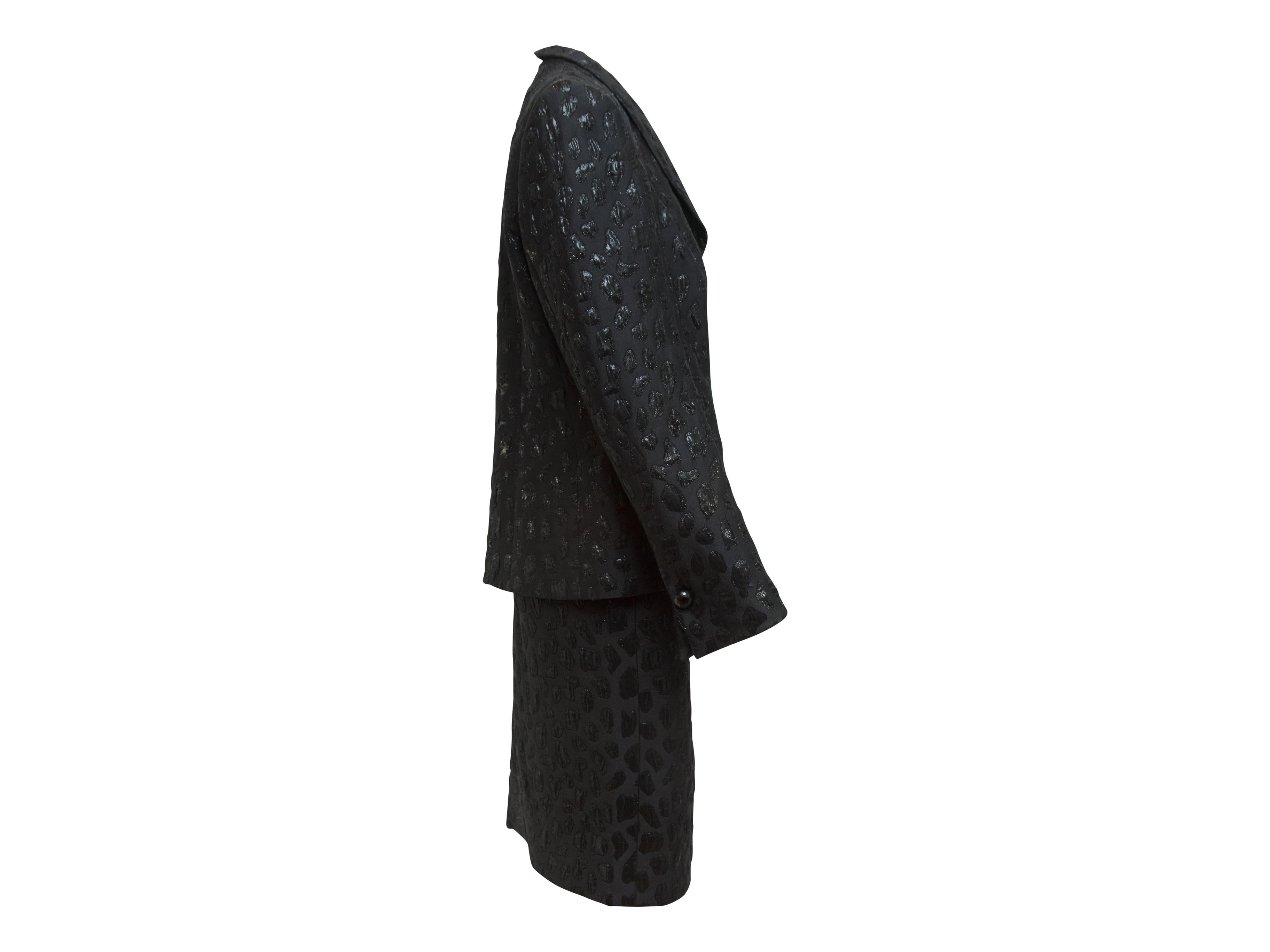 Product details:  Vintage metallic black jacquard skirt suit set by Givenchy.  Shawl collar.  Long sleeves.  Single button cuffs.  Button-front closure.  Matching skirt.  42