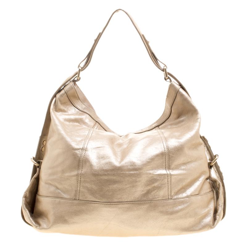 For the ones who love bling and cannot live without it comes the Givenchy Metallic Gold Leather Hobo. A spacious interior that can carry almost all your necessities is covered by a shiny metallic leather exterior and closed by a zipper. This bag is