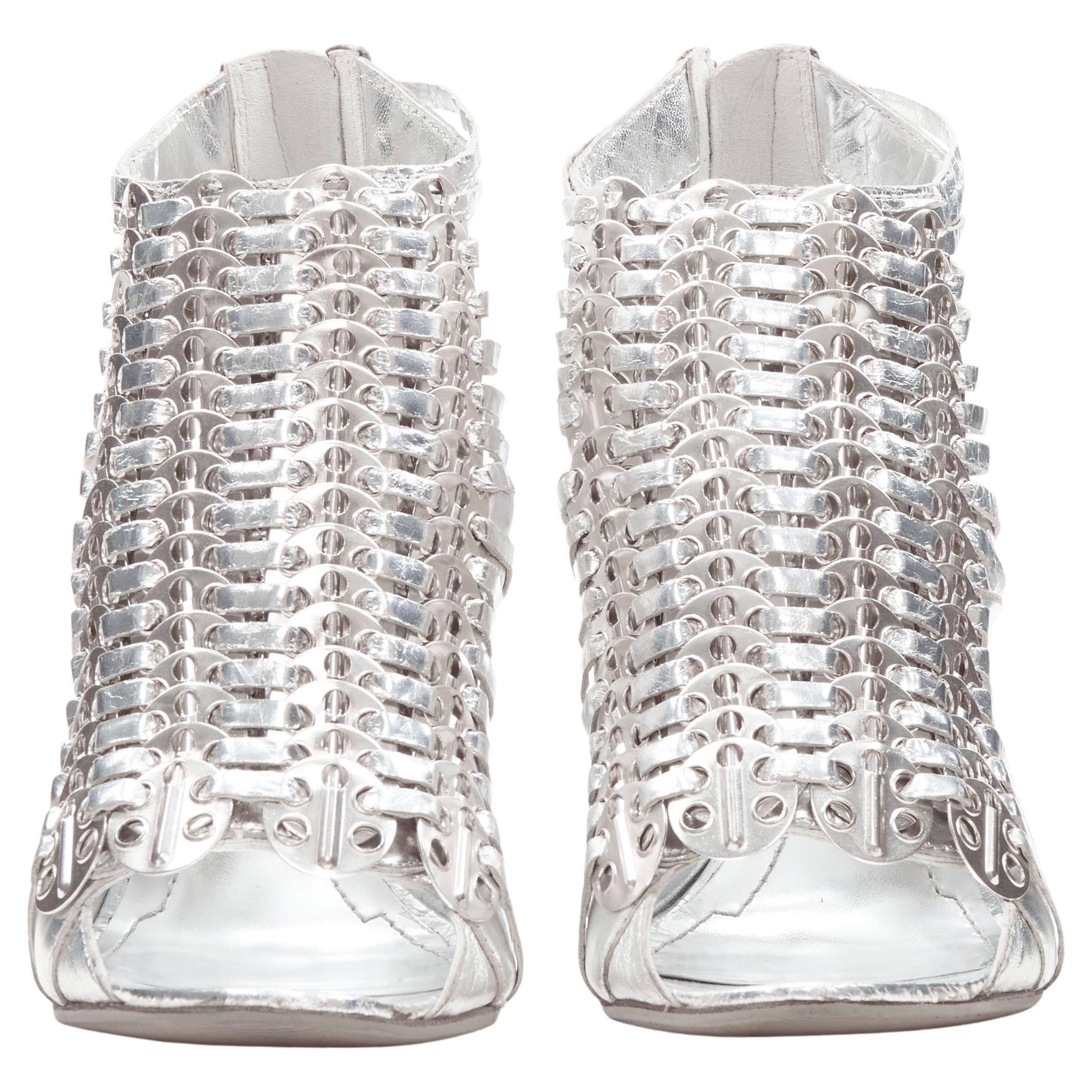 GIVENCHY metallic silver metal discs embellished strappy peep toe bootie EU36.5
Brand: Givenchy
Designer: Riccardo Tisci
Collection: 2010 
Material: Leather
Color: Silver
Pattern: Solid
Closure: Zip
Extra Detail: Wrinkled leather. Metal disc