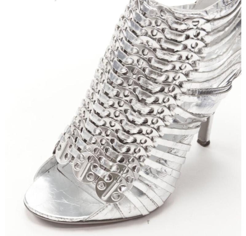 GIVENCHY metallic silver metal discs embellished strappy peep toe bootie EU36.5
Reference: ANWU/A00986
Brand: Givenchy
Designer: Riccardo Tisci
Collection: 2010
Material: Leather
Color: Silver
Pattern: Solid
Closure: Zip
Lining:  Leather
Extra