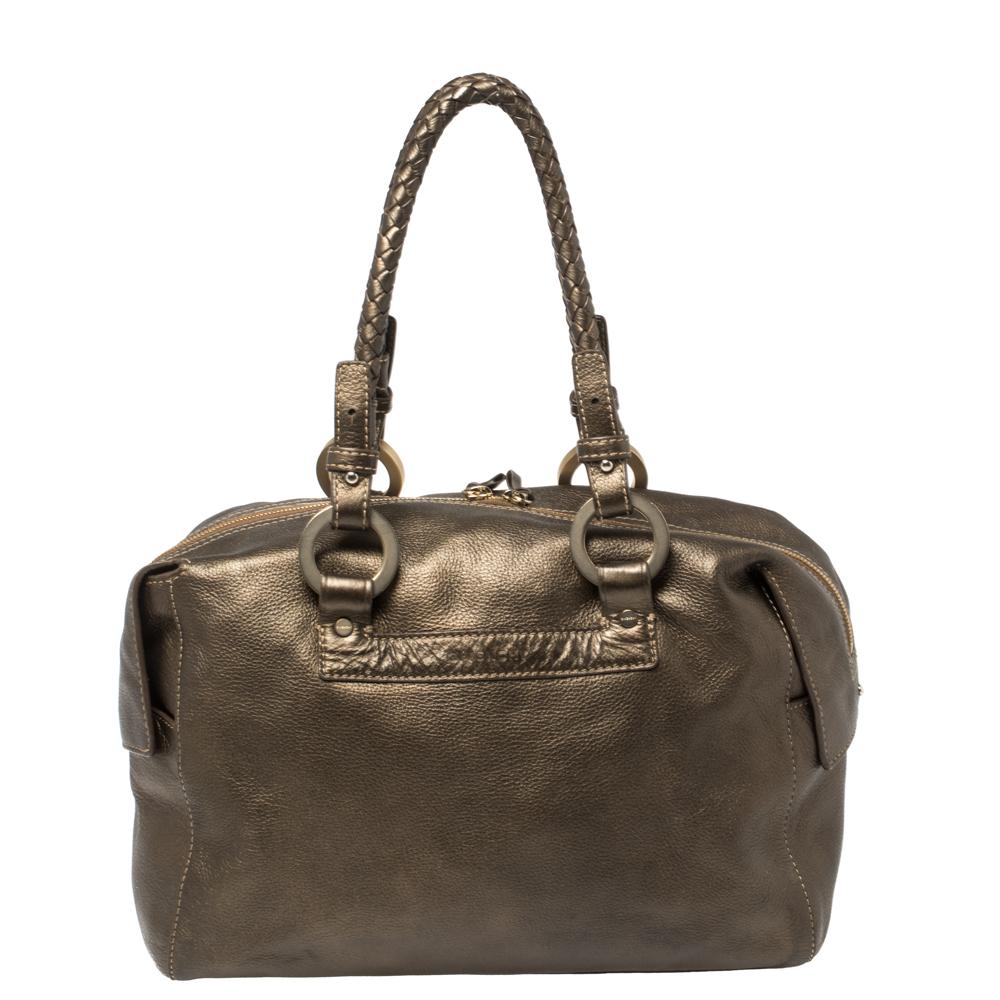 Stunning in appeal and high on style, this Givenchy satchel has been crafted from soft leather and designed minimally with gold-tone hardware. It comes with dual braided top handles and the brand logo embossed in the front. The fabric-lined interior