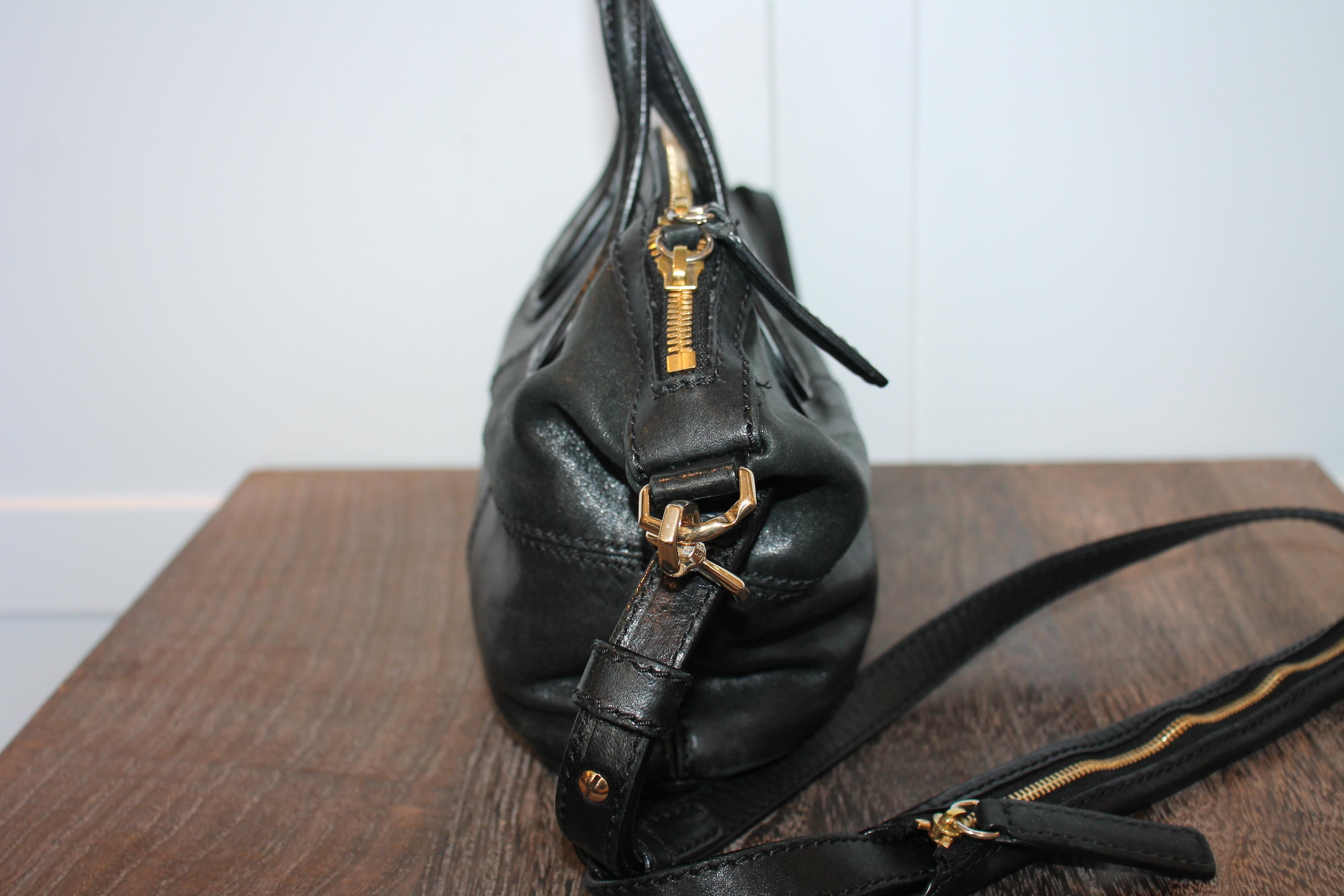 Black lambskin Givenchy Micro Nightingale satchel with gold-tone hardware, dual flat top handles, detachable flat shoulder strap, tonal canvas lining, dual interior pockets; one with zip closure and two-way zip closure at top.