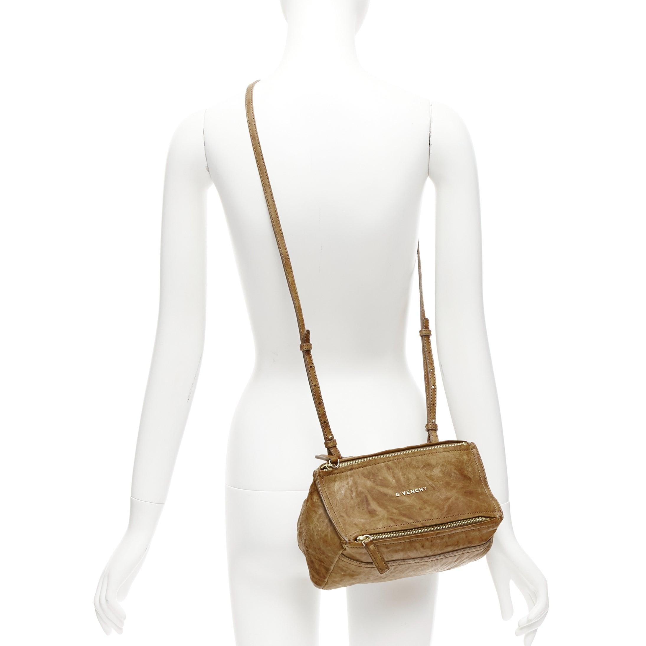 GIVENCHY Mini Pandora brown washed textured leather gold logo crossbody bag
Reference: CELG/A00410
Brand: Givenchy
Designer: Riccardo Tisci
Model: Mini Pandora
Material: Leather, Metal
Color: Brown, Gold
Pattern: Solid
Closure: Zip
Lining: Black