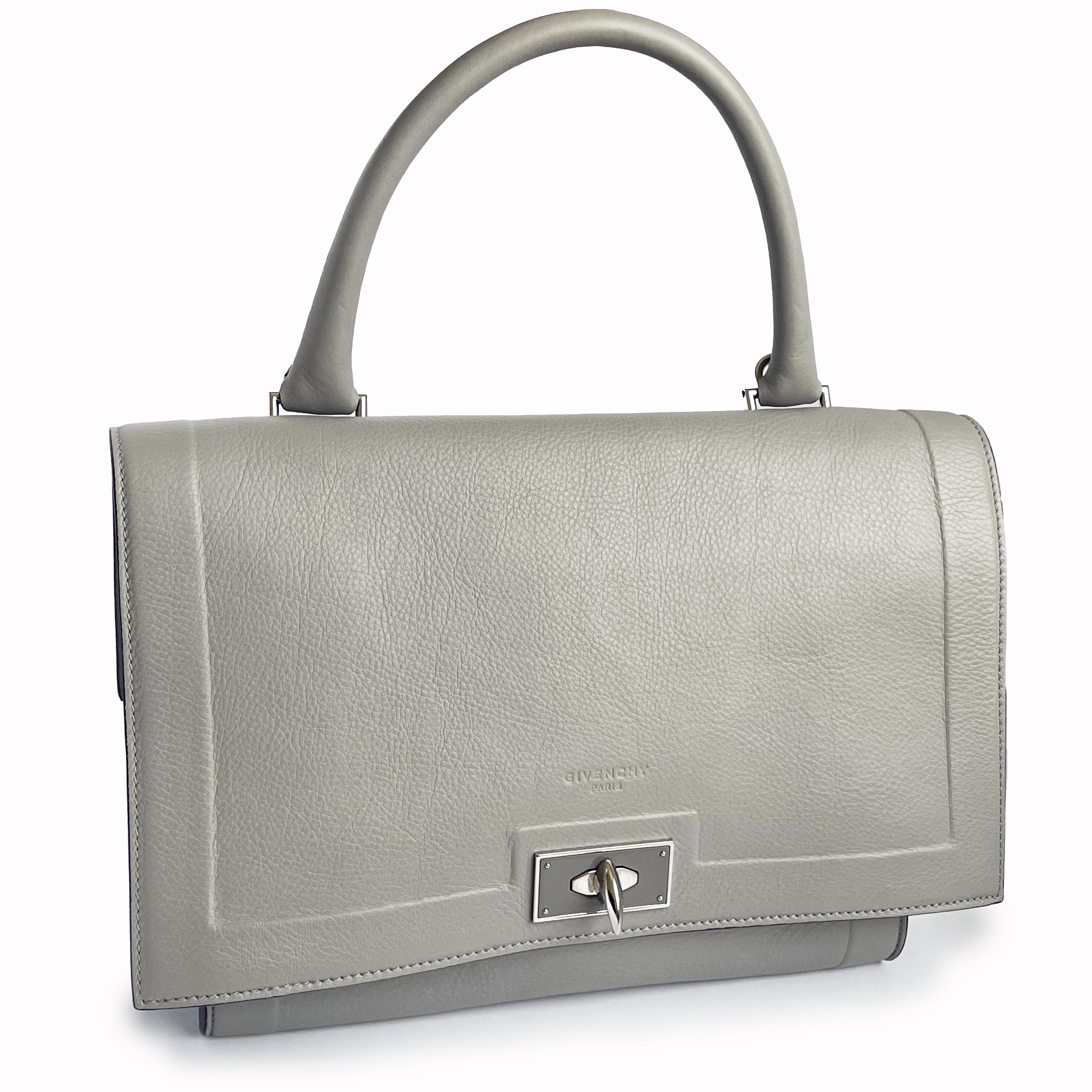 Authentic, preowned Givenchy 'Mini' Shark Tooth satchel or top handle bag. Made from light gray leather, it has a top flap that fastens with a silver metal 