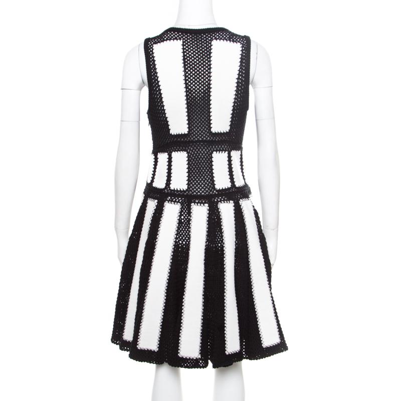 Isn't this Givenchy dress absolutely stunning! The monochrome creation is made of 100% cotton and features a pleated bottom silhouette. It flaunts an open knit panel design and silver-tone studs that are artistically embellished on it. It comes with