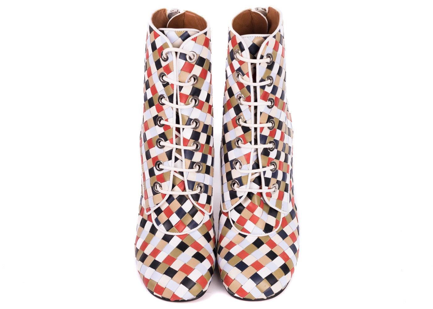 Set the trend and lead the way in your Givenchy's Woven Booties. These show stoppers include woven multicolored leather strips, white lacing, and Givenchy's signature metal tipped curved heel. Give everyone a show with your silver studded soles as