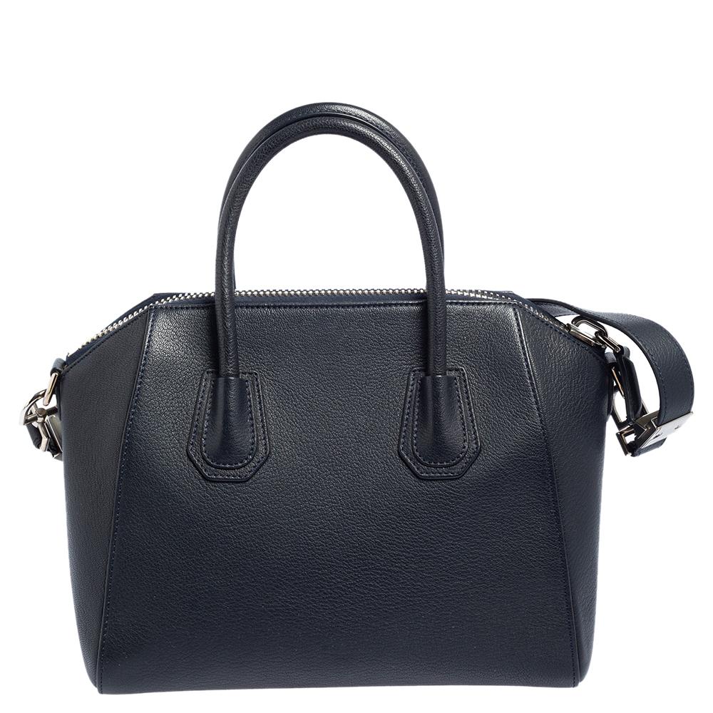 Made in Italy, and loved by women worldwide is this beautiful Antigona satchel by Givenchy. It has been crafted from leather and shaped elegantly. The navy blue bag has a top zipper that reveals a canvas interior and it is held by two top handles