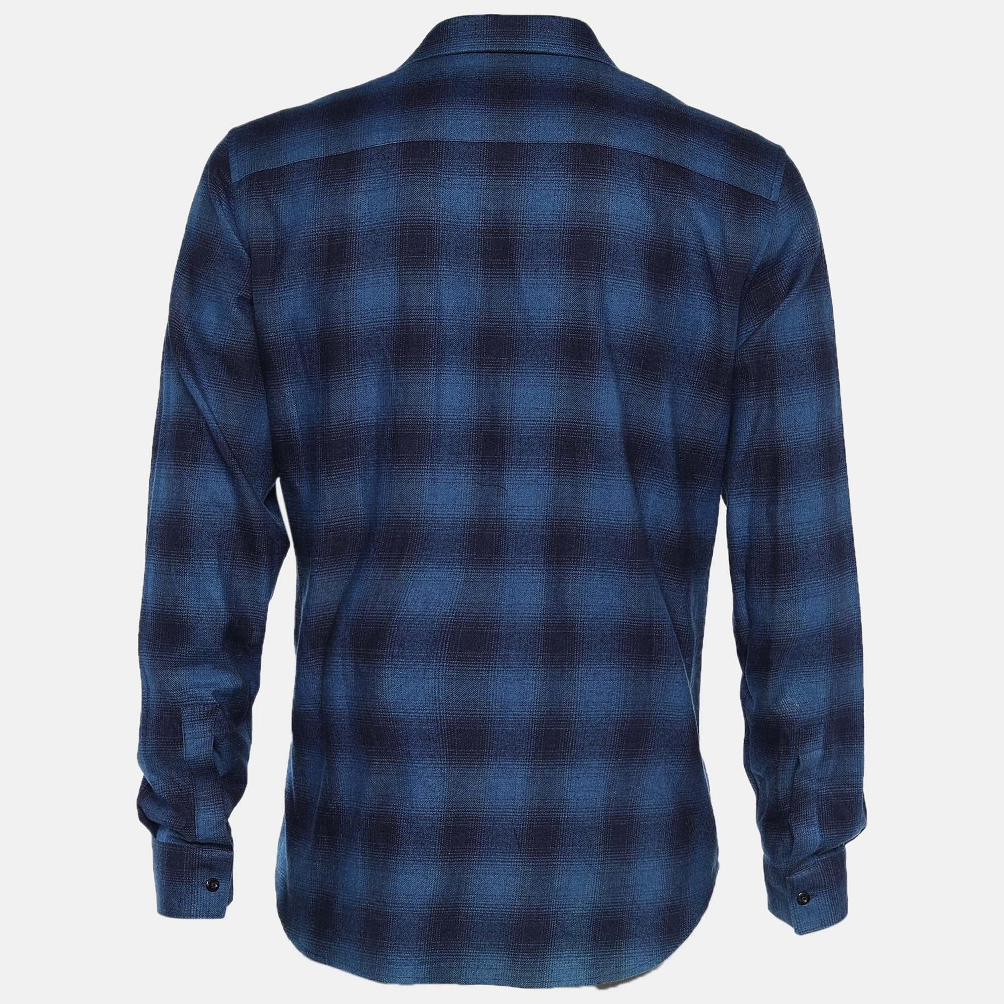 Enhance your collection with this shirt from the House of Givenchy. It is designed using navy-blue cotton fabric, which is highlighted with plaid flannel detail. It flaunts a Stars patch on the front, long sleeves, and buttoned closures. Look classy