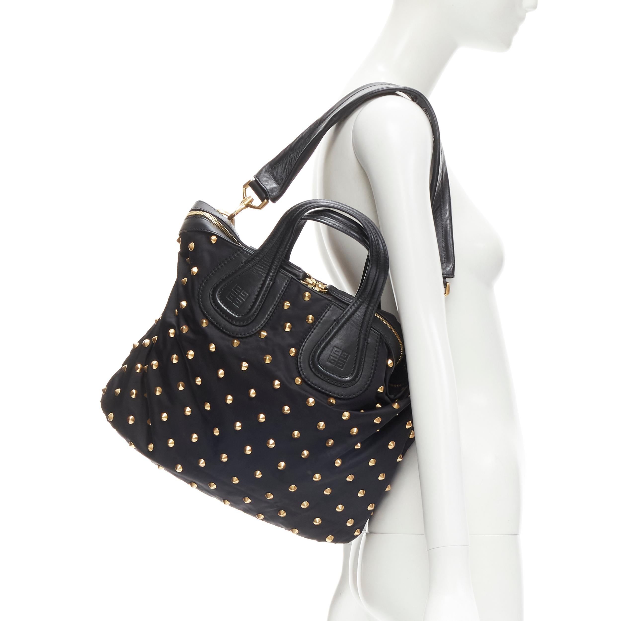 GIVENCHY Nightingale black nylon gold spiek studded crossbody hobo bag
Brand: Givenchy
Designer: Riccardo Tisci
Model: Nightingale
Material: Nylon
Color: Black
Pattern: Solid
Closure: Zip
Extra Detail: Black nylon body with gold-tone sspike stud.