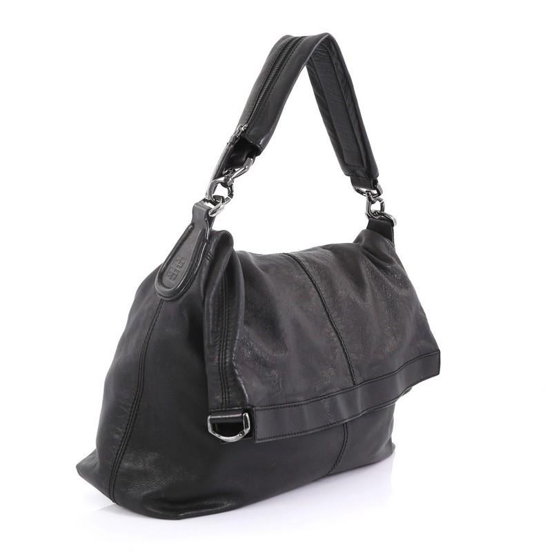 This Givenchy Nightingale Convertible Hobo Leather Large, crafted in black leather, features detachable top handle and gunmetal-tone hardware. Its magnetic closure opens to a black fabric interior. 

Estimated Retail Price: $2,940
Condition: Very