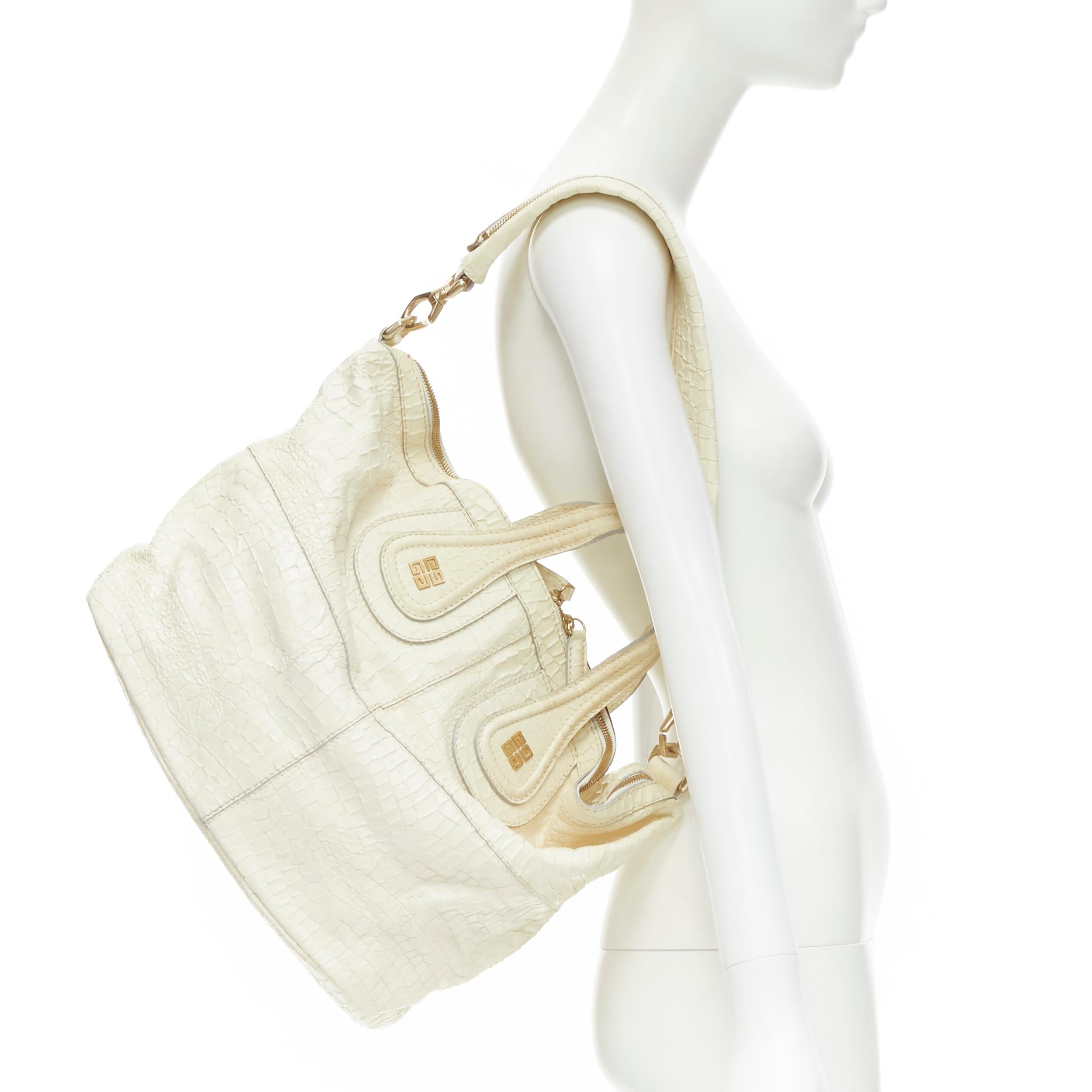 GIVENCHY Nightingale cream white embossed leather shoulder hobo tote bag 
Reference: CELG/A00145 
Brand: Givenchy 
Model: Nightingale 
Material: Leather 
Color: White 
Pattern: Solid 
Closure: Zip Extra 
Detail: Mock croc leather. Gold-tone