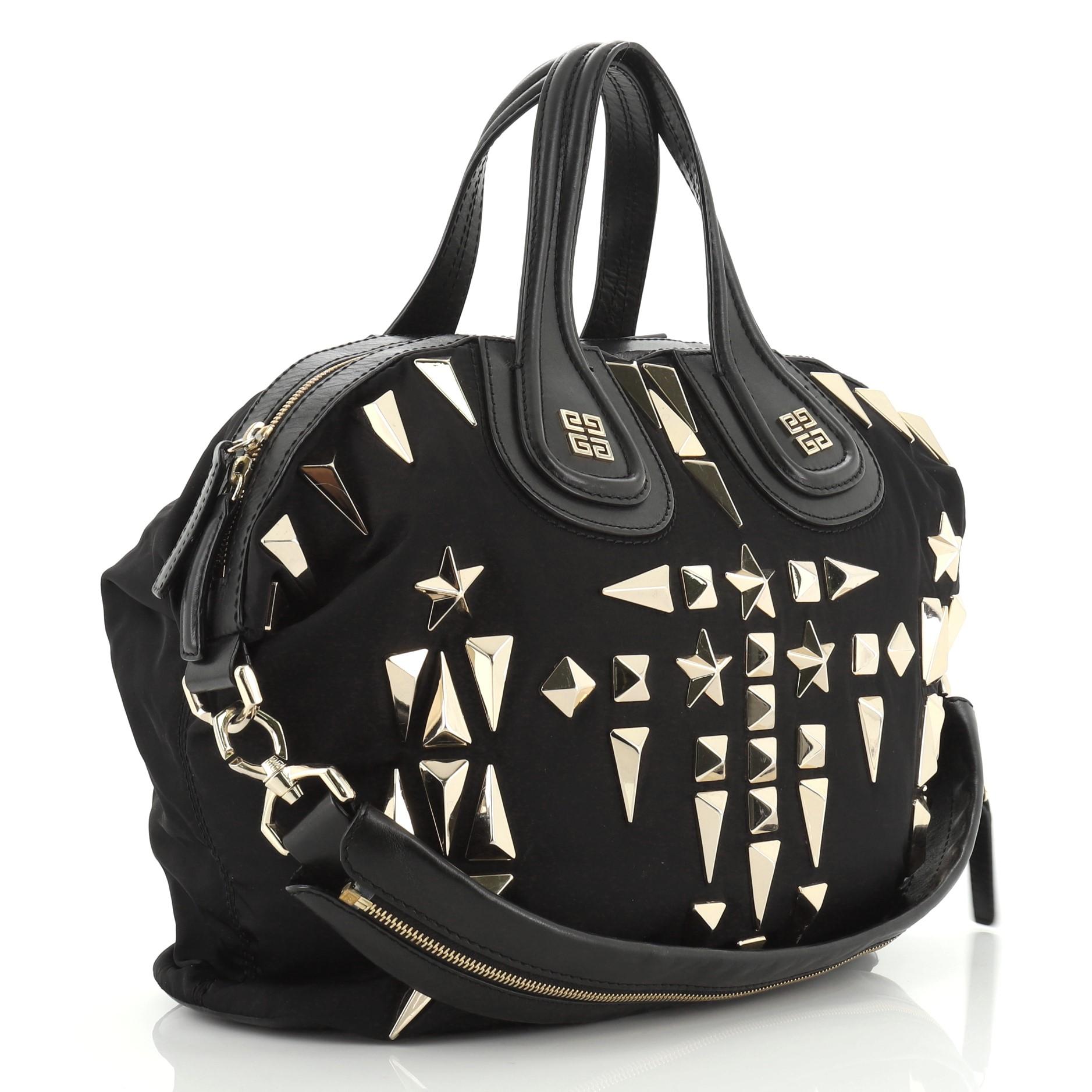 This Givenchy Nightingale Satchel Studded Nylon Medium, crafted in black studded nylon, features dual leather handles and gold-tone hardware. Its zip closure opens to a black fabric interior with zip and slip pockets. 

Estimated Retail Price: