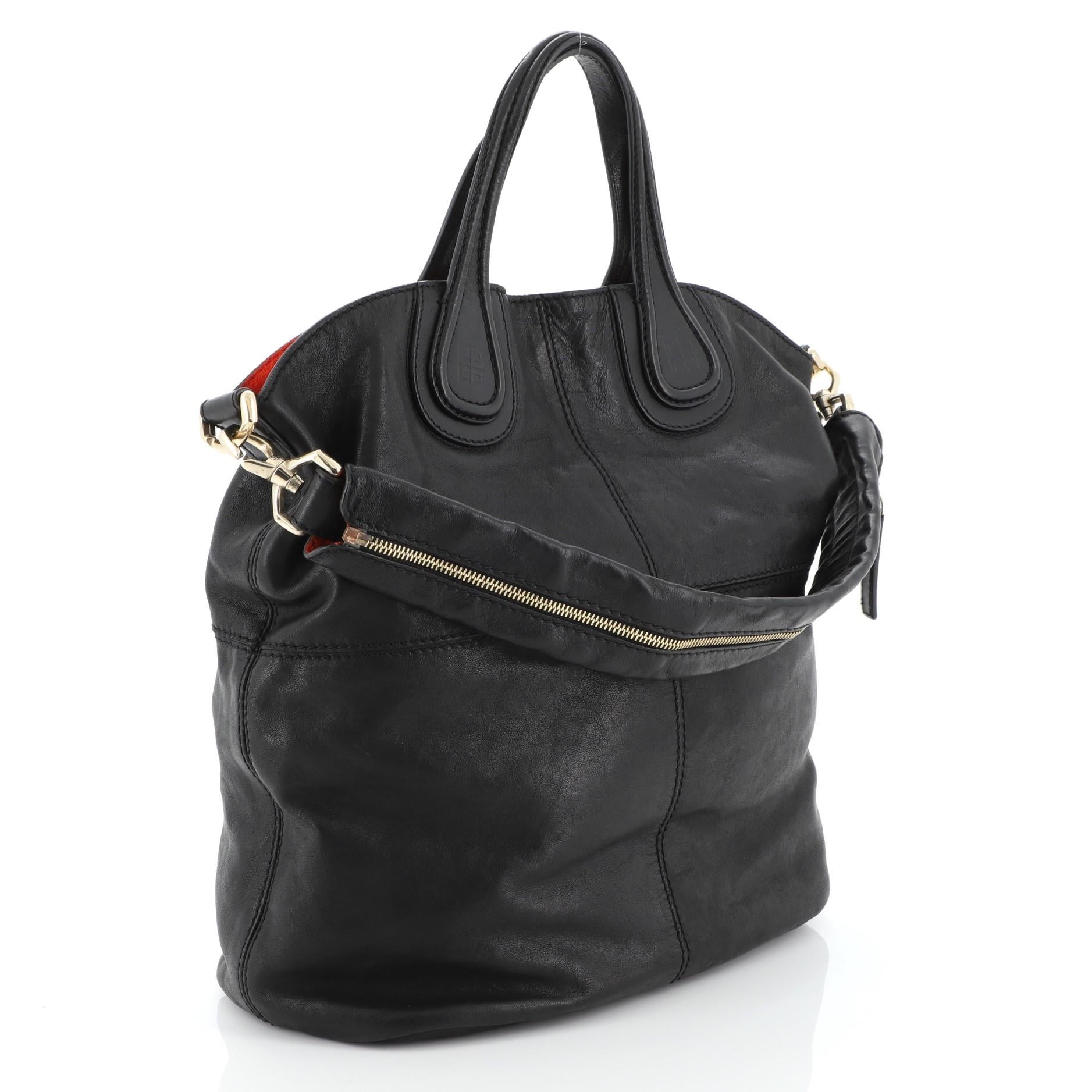 This Givenchy Nightingale Tote Leather Large, crafted in black leather, features dual top handles with embossed Givenchy logo, stitched quarters, and gold-tone hardware. Its hidden magnetic closure opens to a black fabric interior with zip and slip