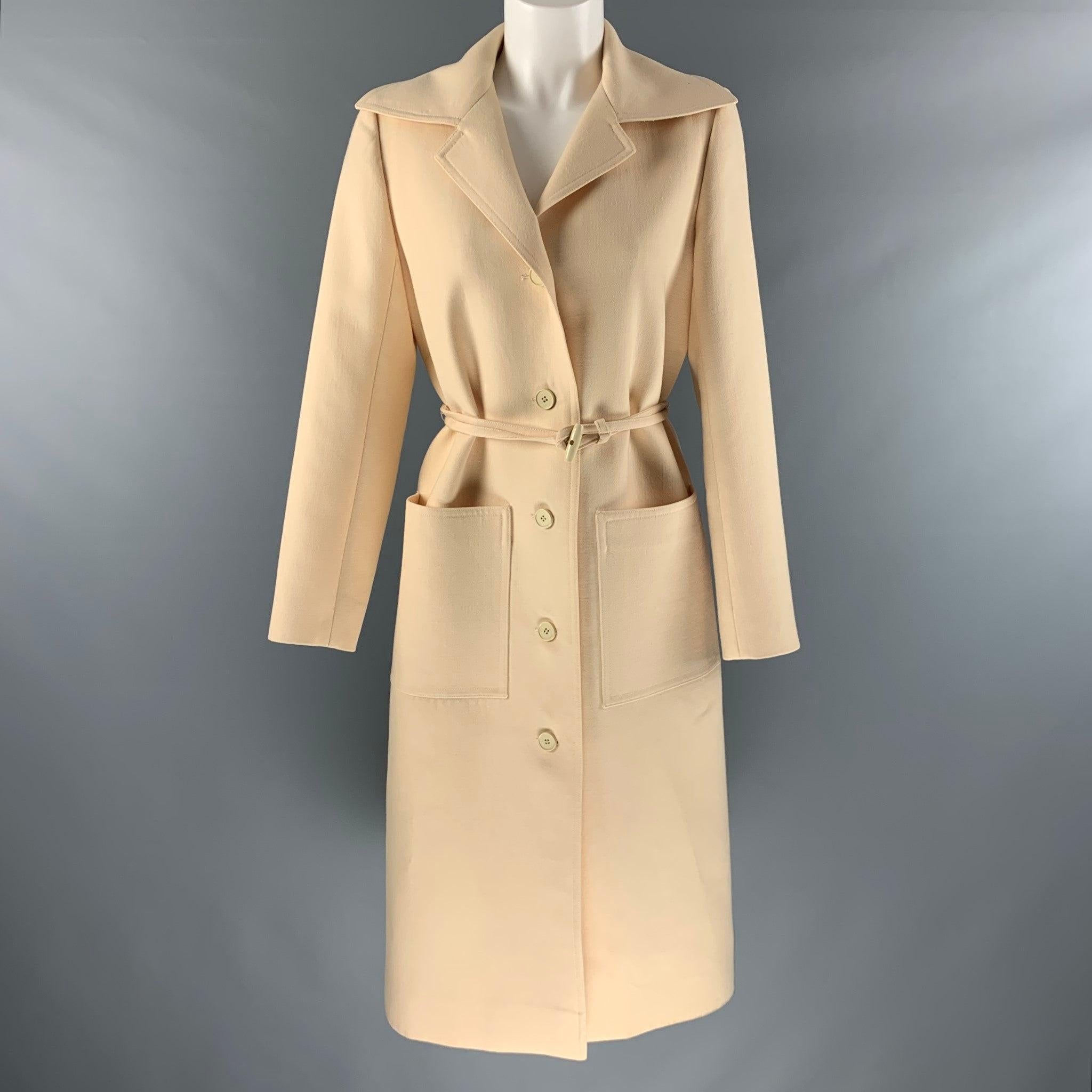 GIVENCHY Nouvelle Boutique by HUBERT vintage coat comes in a cream twill featuring a notch lapel, patch pockets, belted, and a four button closure. Made in France.Excellent Pre-Owned Condition. 

Marked:  no size market. 

Measurements: 
 
Shoulder: