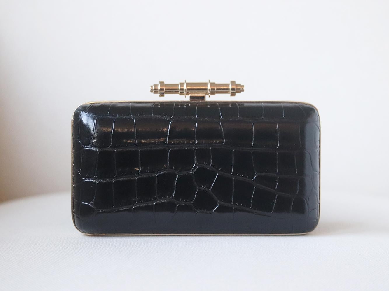 Givenchy showcases its flair for dramatic and statement-making design with this Obsedia box clutch, it’s beautifully crafted from black croc-effect leather and adorned gold-tone metal clasp and matching chain.
Black croc-effect leather.
Clasp
