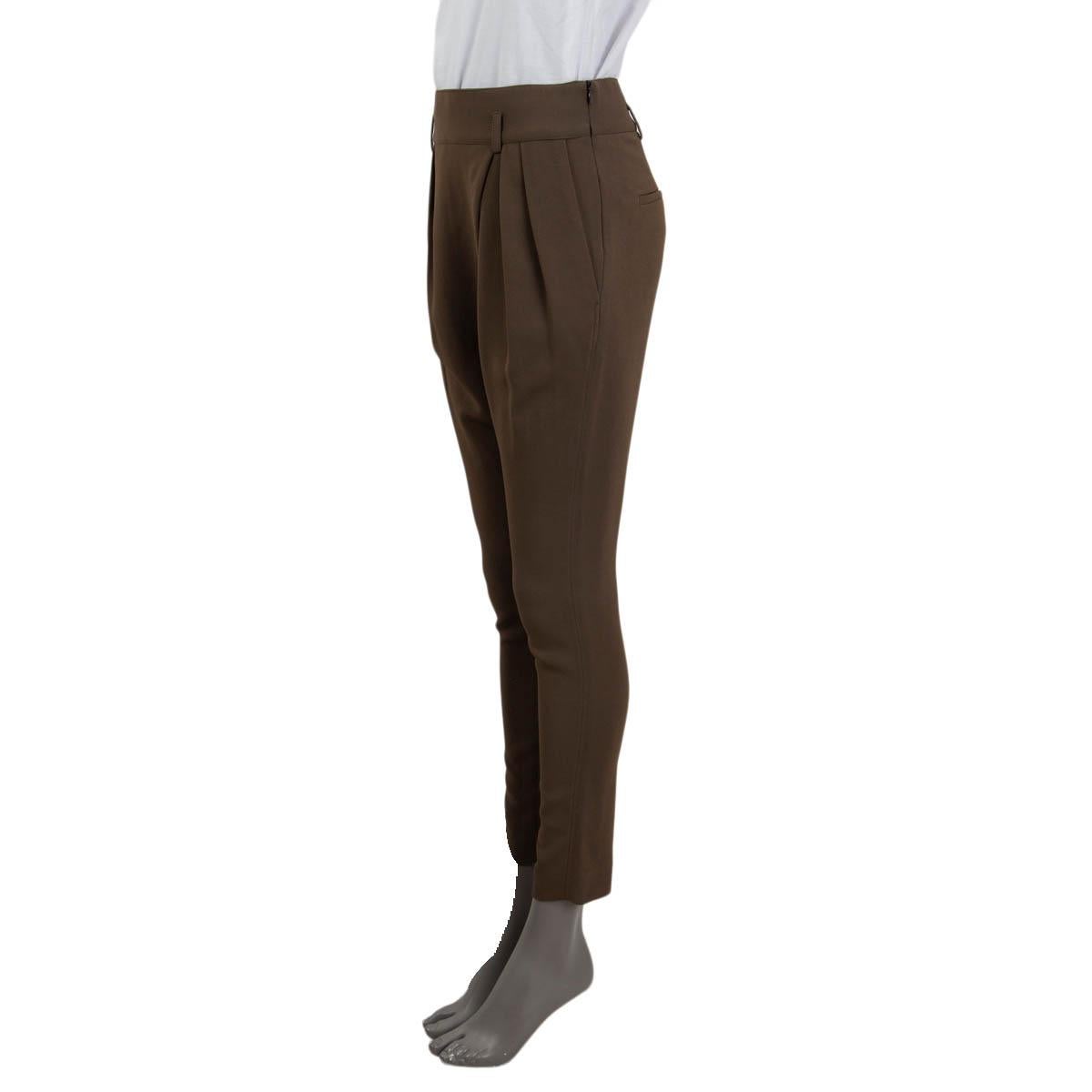 100% authentic Givenchy asymmetrical pleated pants in khaki viscose (95%) and elastane (5%). Feature two slit pockets on the side, two at the back and belt loops. Open with a concealed zipper and a hook at the side. Pockets lined in khaki cupro