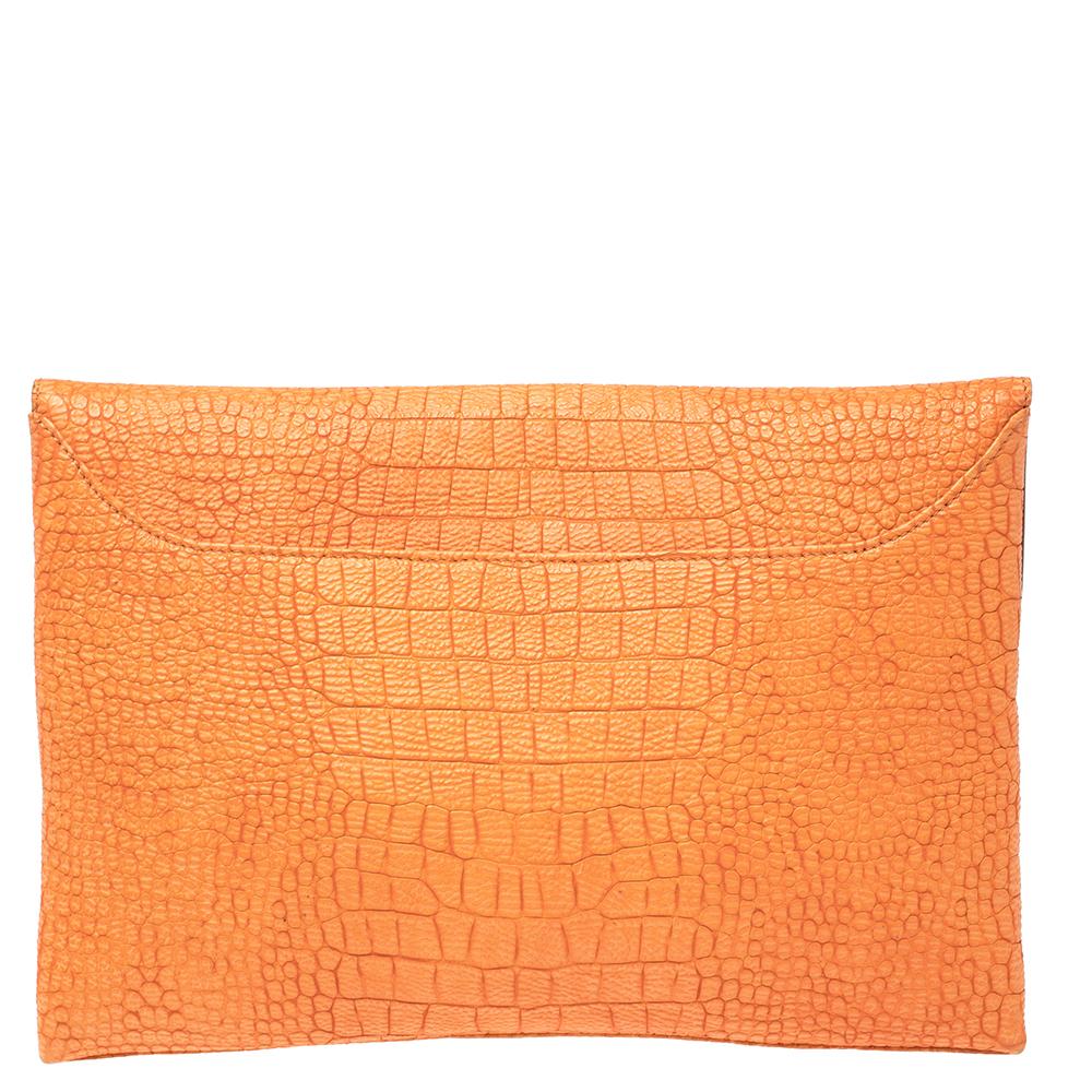 Givenchy's Antigona clutch is crafted from orange croc-embossed leather in an envelope style. It opens to a fabric-lined interior that can easily hold your day to day essentials. It is finished with the brand logo on the front. Use it for evening