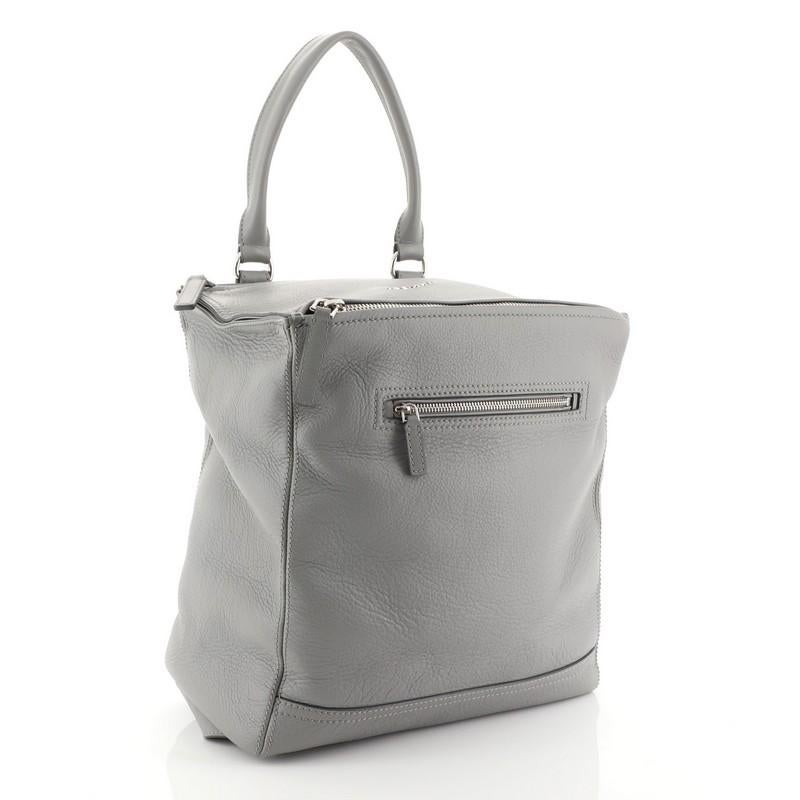 This Givenchy Pandora Backpack Leather, crafted from gray leather, features a leather top handle, adjustable shoulder straps, exterior front zip pocket, and silver-tone hardware. Its top zip closure opens to a black fabric interior with zip and slip