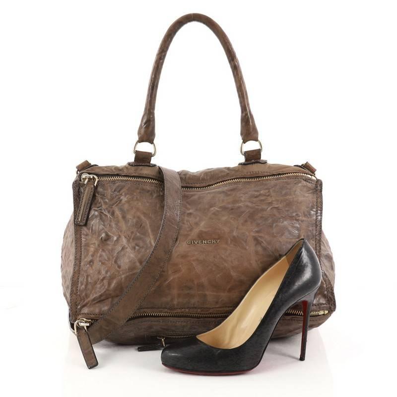 This authentic Givenchy Pandora Bag Distressed Leather Large is the perfect companion for any on-the-go fashionista. Crafted from brown distressed leather, this cult-favorite satchel features a pandora box-inspired silhouette, a singular top handle,