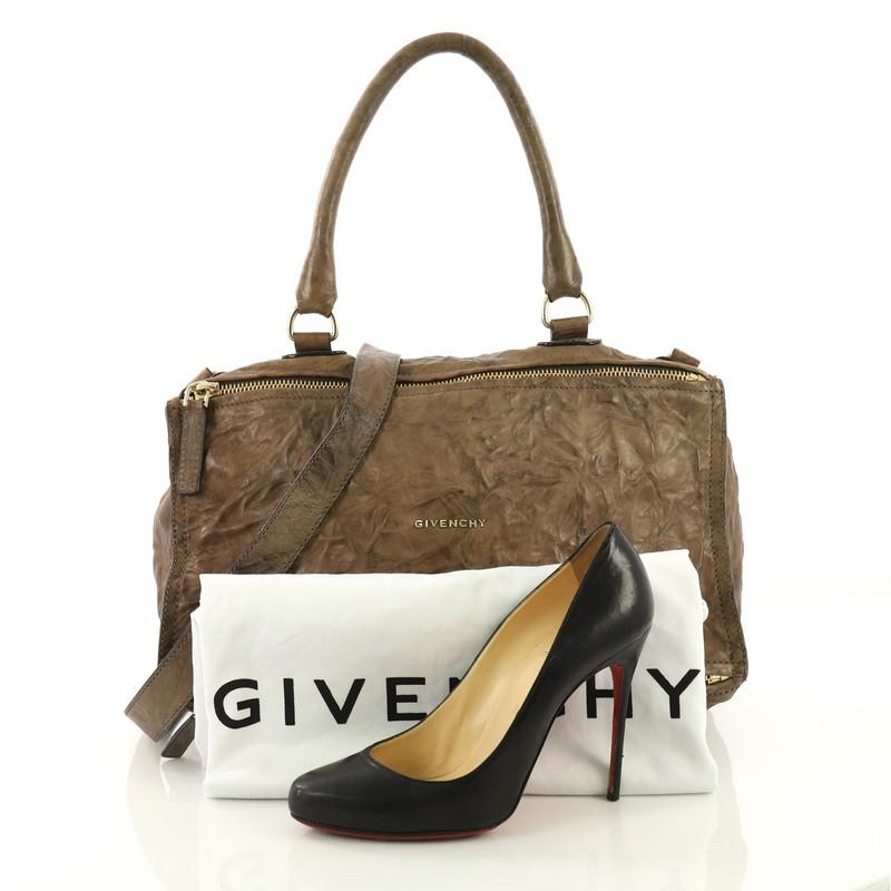 This Givenchy Pandora Bag Distressed Leather Large, crafted from brown distressed leather, features a top handle, an exterior zip pocket, and gold-tone hardware. Its two-way zip fastenings open to a black fabric interior with side zip and slip