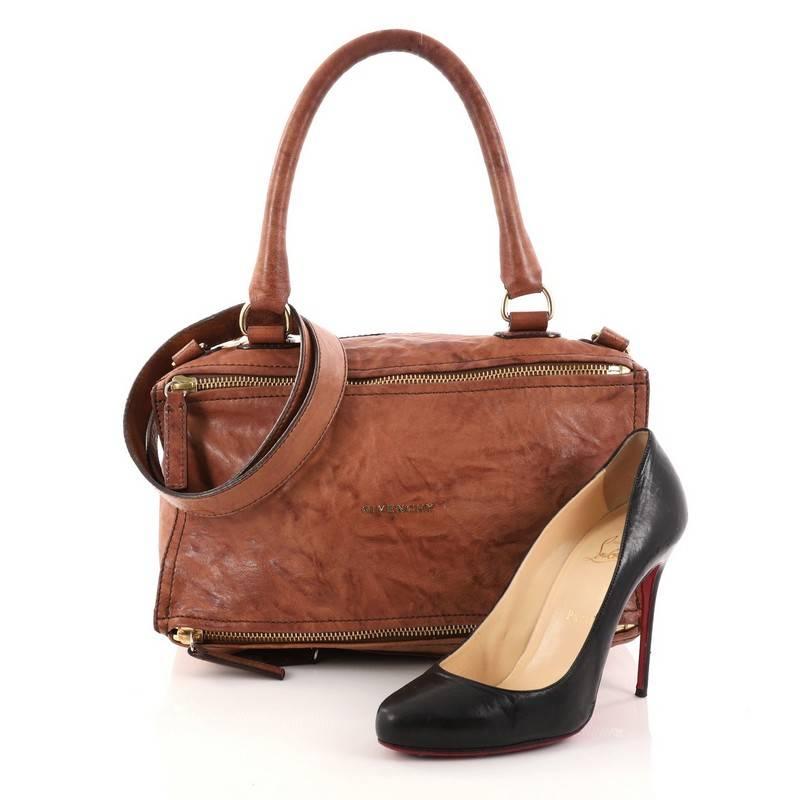 This authentic Givenchy Pandora Bag Distressed Leather Medium is the perfect companion for any on-the-go fashionista. Crafted from brown distressed leather, this edgy and cult-favorite satchel features a pandora box-inspired silhouette, a singular