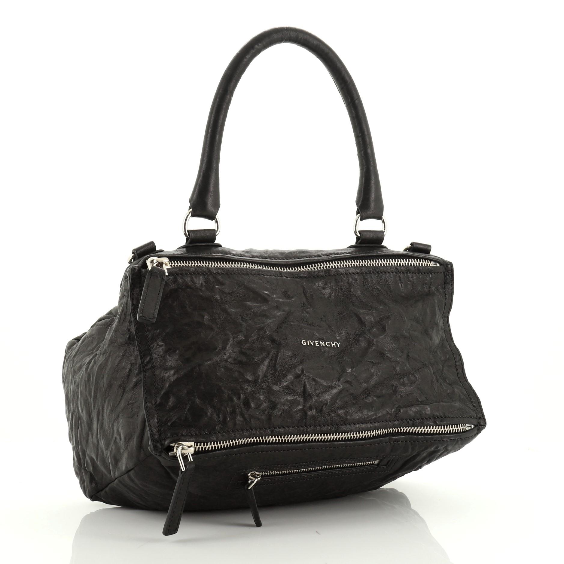 This Givenchy Pandora Bag Distressed Leather Medium, crafted from black distressed leather, features a leather top handle, exterior zip pocket, and silver-tone hardware. Its two-way zip fastenings open to a black fabric interior with side zip and