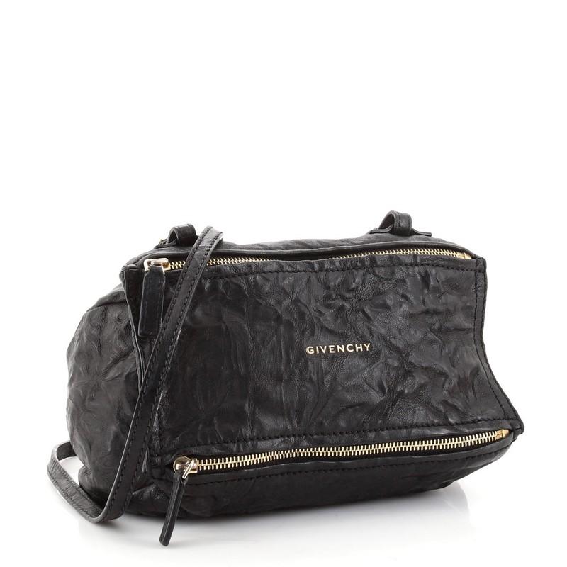 Condition: Fair. Odor in interior. Heavy wear and discoloration on exterior corners, opening edges and zipper pull, creasing on exterior and strap. Moderate cracking and splitting on strap wax edges, wear, discoloration and marks in interior.