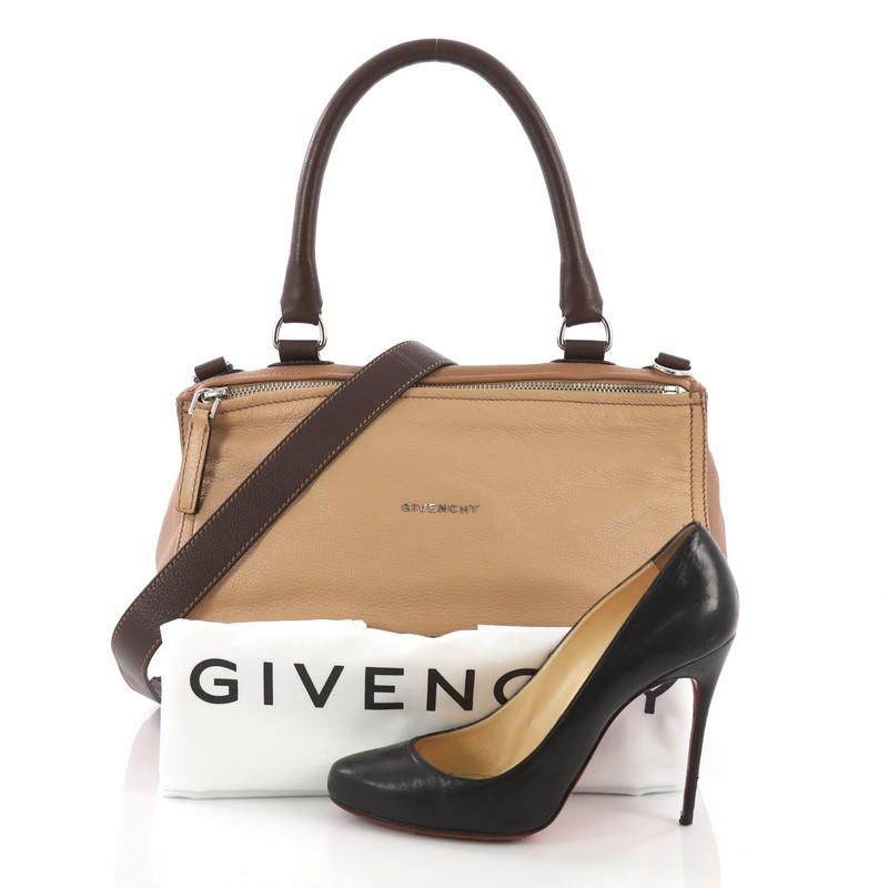 This Givenchy Pandora Bag Leather Medium, crafted from brown leather, features a top handle, an exterior zip pocket, and silver-tone hardware. Its two-way zip fastenings open to a beige fabric interior with side zip and slip pockets. **Note: Shoe