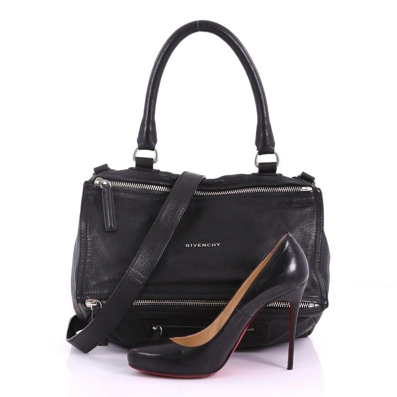 This Givenchy Pandora Bag Leather Medium, crafted from black leather, features a singular top handle, an exterior zip pocket, and silver-tone hardware. Its two-way zip fastenings open to a black fabric interior with side zip and slip pockets.