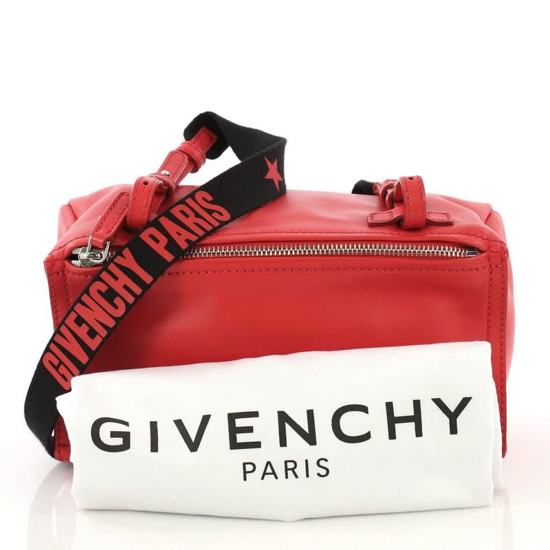 This Givenchy Pandora Bag Leather Mini, crafted in red leather, features a single adjustable strap, front zip compartment, and silver-tone hardware. Its top zip closure opens to a black fabric interior with side zip pocket. 

Estimated Retail Price:
